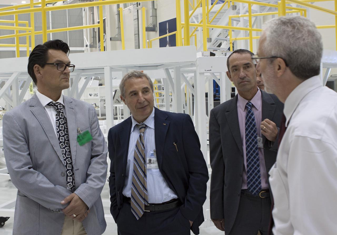 CAPE CANAVERAL, Fla. – Representatives from the European Space Agency, or ESA, toured the Operations and Checkout Building high bay at NASA’s Kennedy Space Center in Florida. From the left, are Nico Dettman, ESA Space Transportation Department director Bernardo Patti, ESA manager of International Space Station Operations Philippe Deloo, ESA European Service Module study manager and Mark Geyer, Orion Production Operations manager.    Orion is the exploration spacecraft designed to carry crews to space beyond low Earth orbit. It will provide emergency abort capability, sustain the crew during the space travel and provide safe re-entry from deep space return velocities. Orion’s first unpiloted test flight is scheduled to launch in 2014 atop a Delta IV rocket. A second uncrewed flight test is scheduled for 2017 on NASA’s Space Launch System rocket. For more information, visit http://www.nasa.gov/orion. Photo credit: NASA/Jim Grossmann