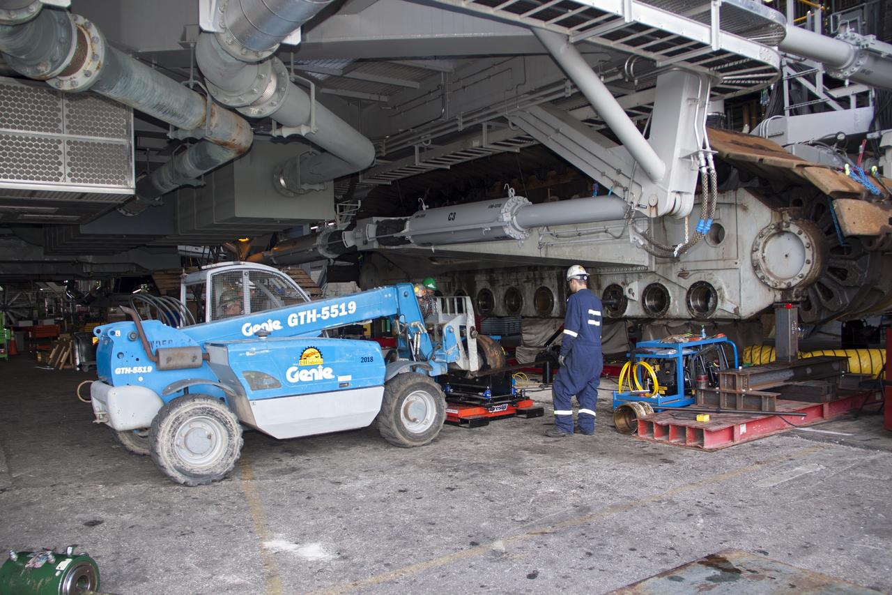 CAPE CANAVERAL, Fla. – Inside the Vehicle Assembly Building at NASA’s Kennedy Space Center in Florida, technicians prepare to install new roller shaft bearings in crawler-transporter 2, or CT-2.    Work continues in high bay 2 to upgrade CT-2. The modifications are designed to ensure CT-2’s ability to transport launch vehicles currently in development, such as the agency’s Space Launch System, to the launch pad. The Ground Systems Development and Operations Program office at Kennedy is overseeing the upgrades. For more than 45 years the crawler-transporters were used to transport the mobile launcher platform and the Apollo-Saturn V rockets and, later, space shuttles to Launch Pads 39A and B. For more information, visit: http://www.nasa.gov/exploration/systems/ground/crawler-transporter_bearings.html. Photo credit: NASA/Jim Grossmann