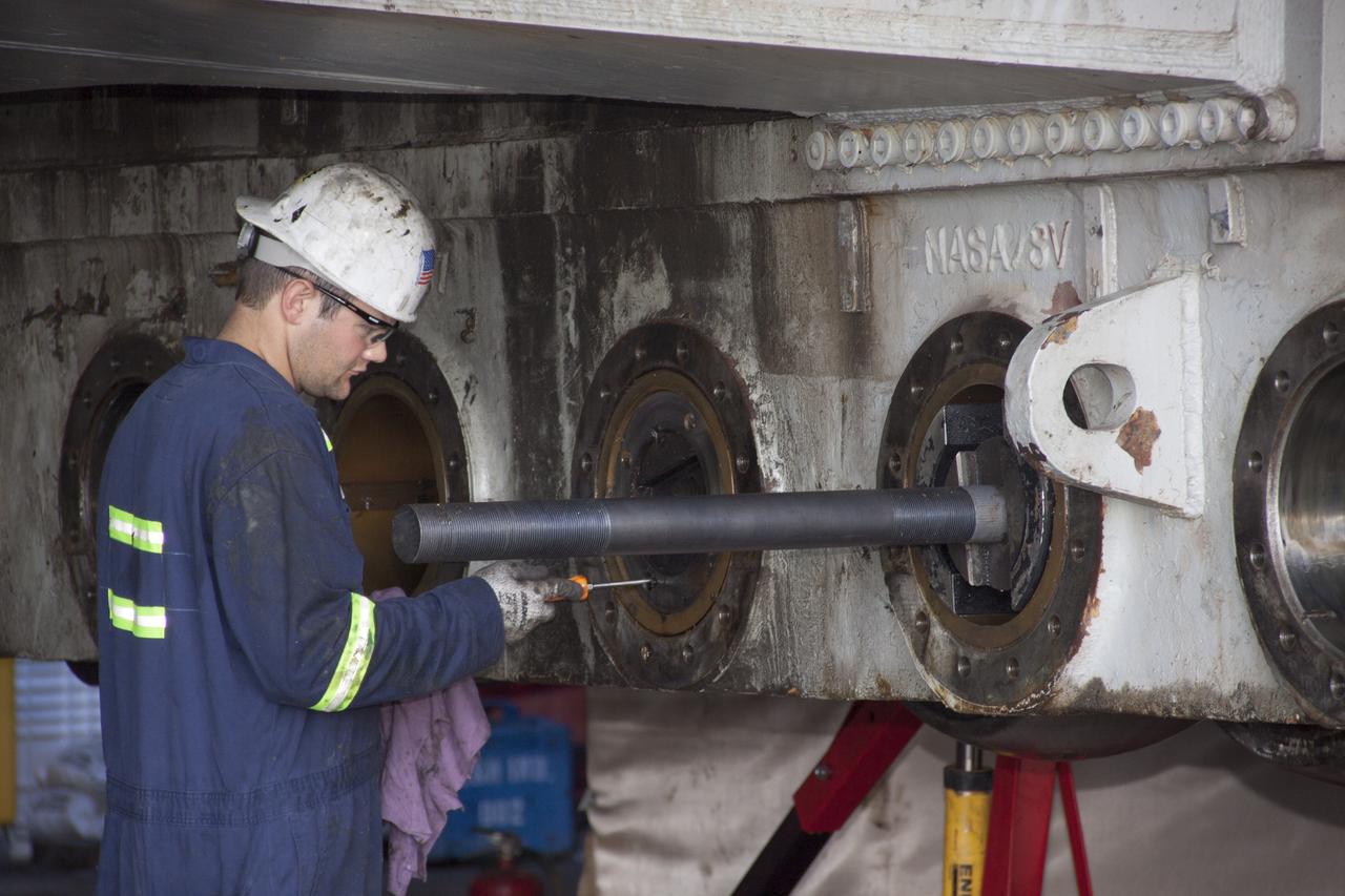 CAPE CANAVERAL, Fla. – Inside the Vehicle Assembly Building at NASA’s Kennedy Space Center in Florida, a technician prepares to install a new roller shaft bearing in crawler-transporter 2, or CT-2.     Work continues in high bay 2 to upgrade CT-2. The modifications are designed to ensure CT-2’s ability to transport launch vehicles currently in development, such as the agency’s Space Launch System, to the launch pad. The Ground Systems Development and Operations Program office at Kennedy is overseeing the upgrades. For more than 45 years the crawler-transporters were used to transport the mobile launcher platform and the Apollo-Saturn V rockets and, later, space shuttles to Launch Pads 39A and B. For more information, visit: http://www.nasa.gov/exploration/systems/ground/crawler-transporter_bearings.html. Photo credit: NASA/Jim Grossmann