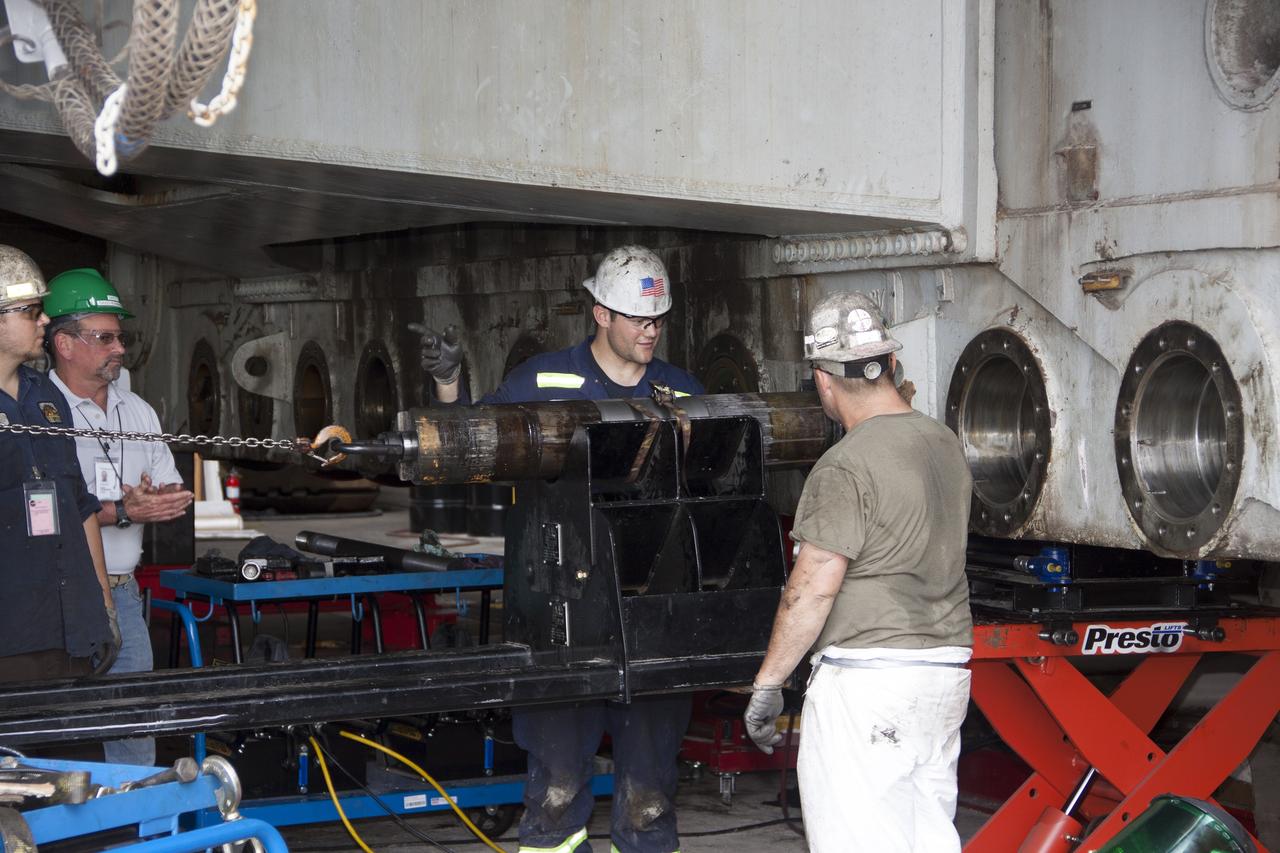 CAPE CANAVERAL, Fla. – Inside the Vehicle Assembly Building at NASA’s Kennedy Space Center in Florida, technicians have removed an old roller shaft bearing from crawler-transporter 2, or CT-2. New roller shaft bearings will be installed on CT-2.     Work continues in high bay 2 to upgrade CT-2. The modifications are designed to ensure CT-2’s ability to transport launch vehicles currently in development, such as the agency’s Space Launch System, to the launch pad. The Ground Systems Development and Operations Program office at Kennedy is overseeing the upgrades. For more than 45 years the crawler-transporters were used to transport the mobile launcher platform and the Apollo-Saturn V rockets and, later, space shuttles to Launch Pads 39A and B. For more information, visit: http://www.nasa.gov/exploration/systems/ground/crawler-transporter_bearings.html. Photo credit: NASA/Jim Grossmann