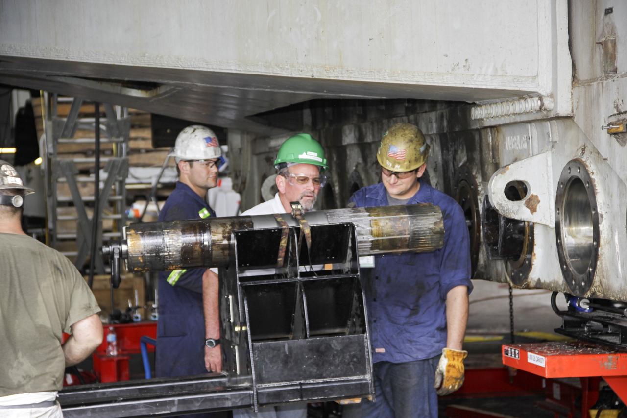 CAPE CANAVERAL, Fla. – Inside the Vehicle Assembly Building at NASA’s Kennedy Space Center in Florida, technicians have removed an old roller shaft bearing from crawler-transporter 2, or CT-2. New roller shaft bearings will be installed on CT-2.     Work continues in high bay 2 to upgrade CT-2. The modifications are designed to ensure CT-2’s ability to transport launch vehicles currently in development, such as the agency’s Space Launch System, to the launch pad. The Ground Systems Development and Operations Program office at Kennedy is overseeing the upgrades. For more than 45 years the crawler-transporters were used to transport the mobile launcher platform and the Apollo-Saturn V rockets and, later, space shuttles to Launch Pads 39A and B. For more information, visit: http://www.nasa.gov/exploration/systems/ground/crawler-transporter_bearings.html. Photo credit: NASA/Jim Grossmann