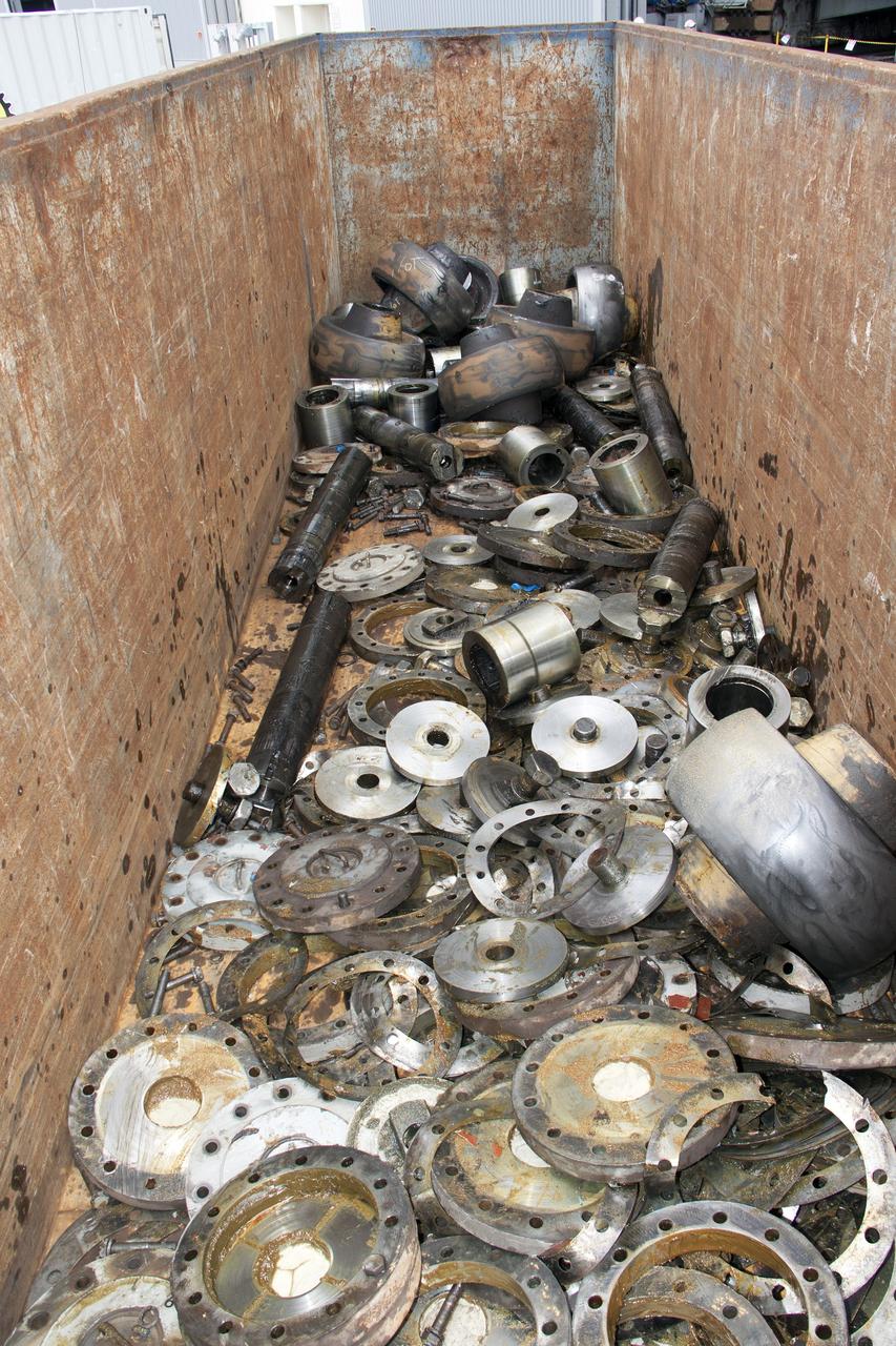 CAPE CANAVERAL, Fla. – Near the Vehicle Assembly Building, or VAB, at NASA’s Kennedy Space Center in Florida, old roller shaft bearing assembly parts that were removed from crawler-transporter 2, or CT-2, have been discarded. Inside the VAB, new roller shaft bearings will be installed on CT-2.      Work continues in high bay 2 to upgrade CT-2. The modifications are designed to ensure CT-2’s ability to transport launch vehicles currently in development, such as the agency’s Space Launch System, to the launch pad. The Ground Systems Development and Operations Program office at Kennedy is overseeing the upgrades. For more than 45 years the crawler-transporters were used to transport the mobile launcher platform and the Apollo-Saturn V rockets and, later, space shuttles to Launch Pads 39A and B. For more information, visit: http://www.nasa.gov/exploration/systems/ground/crawler-transporter_bearings.html. Photo credit: NASA/Jim Grossmann