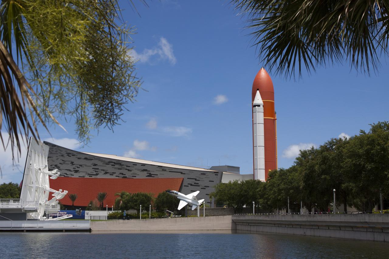 CAPE CANAVERAL, Fla. – At Kennedy Space Center Visitor Complex in Florida, replica external fuel tank and solid rocket boosters mark the entrance to the new Space Shuttle Atlantis exhibit. The new $100 million facility includes interactive exhibits that tell the story of the 30-year Space Shuttle Program and highlight the future of space exploration. Visitors to the exhibit will get an up close look at Atlantis with its payload bay doors open, similar to how it looked in space. Photo credit: NASA/Jim Grossmann