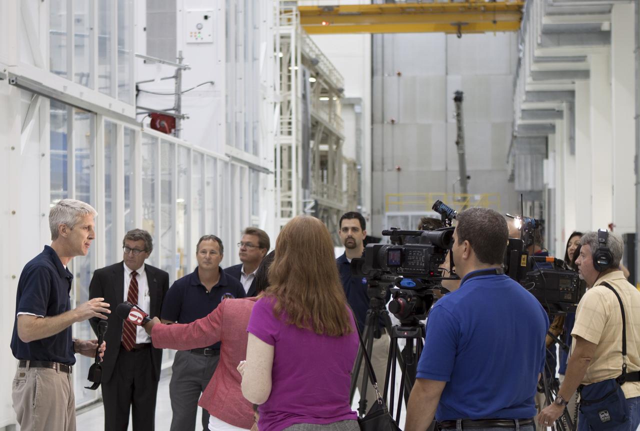 CAPE CANAVERAL, Fla. – Inside the Operations and Checkout Building high bay at NASA’s Kennedy Space Center in Florida, members of the media receive an on activities in NASA’s Ground Systems Development and Operations, or GSDO, Program, Space Launch System and Orion crew module for Exploration Test Flight 1. Speaking to the media, from left are Scott Wilson, manager of Orion Production Operations at Kennedy Larry Price, Lockheed Martin deputy program manager for Orion Tom Erdman, from Marshall Space Flight Center’s Kennedy resident office Jules Schneider, Lockheed Martin manager of Orion Production Operations and Jeremy Parsons, chief of the GSDO Operations Integration Office at Kennedy.    Orion is the exploration spacecraft designed to carry crews to space beyond low Earth orbit. It will provide emergency abort capability, sustain the crew during the space travel and provide safe re-entry from deep space return velocities. Orion’s first unpiloted test flight is scheduled to launch in 2014 atop a Delta IV rocket. A second uncrewed flight test is scheduled for 2017 on NASA’s Space Launch System rocket. For more information, visit http://www.nasa.gov/orion. Photo credit: NASA/Jim Grossmann