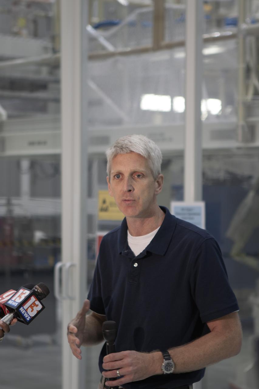 CAPE CANAVERAL, Fla. – Inside the Operations and Checkout Building high bay at NASA’s Kennedy Space Center in Florida, members of the media receive an on activities in NASA’s Ground Systems Development and Operations, or GSDO, Program, Space Launch System and Orion crew module for Exploration Test Flight 1. Speaking to the media is Scott Wilson, manager of Orion Production Operations at Kennedy.    Orion is the exploration spacecraft designed to carry crews to space beyond low Earth orbit. It will provide emergency abort capability, sustain the crew during the space travel and provide safe re-entry from deep space return velocities. Orion’s first unpiloted test flight is scheduled to launch in 2014 atop a Delta IV rocket. A second uncrewed flight test is scheduled for 2017 on NASA’s Space Launch System rocket. For more information, visit http://www.nasa.gov/orion. Photo credit: NASA/Jim Grossmann