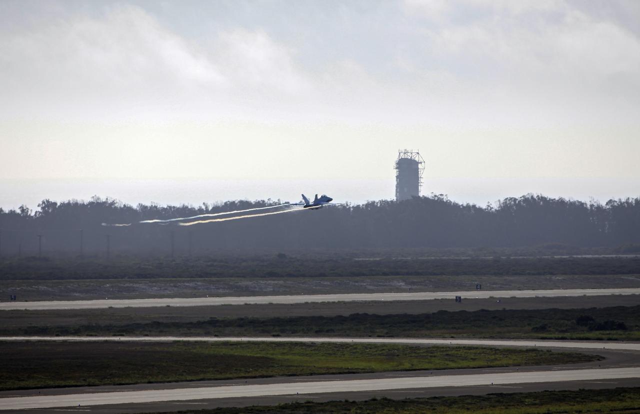 VANDENBERG AIR FORCE BASE, Calif. – An F-18 aircraft flies by a launch pad as it departs from Vandenberg Air Force Base in California. The plane will serve as the "chase plane" accompanying the Orbital Sciences L-1011 aircraft as it transports the Pegasus XL rocket carrying NASA's Interface Region Imaging Spectrograph, or IRIS, solar observatory over the Pacific Ocean. Release of the rocket from under the wing of the L-1011 is scheduled for 10:27 p.m. EDT. IRIS will open a new window of discovery using spectrometry and imaging to trace the flow of energy and plasma through the chromospheres and transition region into the sun’s corona. The spacecraft will observe how solar material moves, gathers energy and heats up as it travels through a largely unexplored region of the solar atmosphere. This interface region, located between the sun's visible surface and its upper atmosphere, is where most of its ultraviolet emission is generated. These emissions impact the near-Earth space environment and Earth's climate. NASA's Launch Services Program at the agency's Kennedy Space Center in Florida is managing the countdown and launch. For more information, visit http://www.nasa.gov/iris. Photo credit: NASA/Daniel Casper
