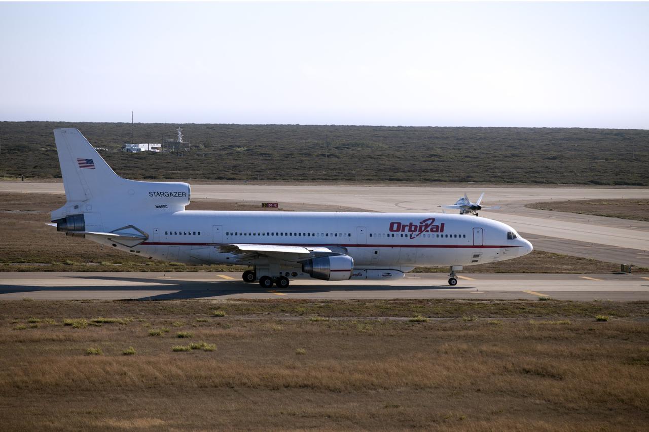 VANDENBERG AIR FORCE BASE, Calif. – A NASA F-18 and an Orbital Sciences L-1011 carrier aircraft taxi to the runway at Vandenberg Air Force Base, Calif., before taking off on a mission to launch NASA's IRIS spacecraft into low-Earth orbit. IRIS, short for Interface Region Imaging Spectrograph, was launched aboard an Orbital Sciences Pegasus XL rocket released from the L-1011. Photo credit: NASA/Daniel Casper