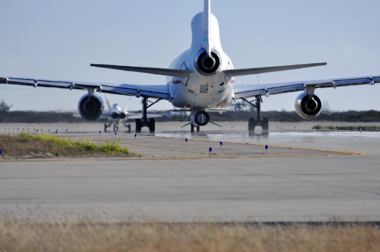 VANDENBERG AIR FORCE BASE, Calif. – A NASA F-18 and an Orbital Sciences L-1011 carrier aircraft taxi to the runway at Vandenberg Air Force Base, Calif., before taking off on a mission to launch NASA's IRIS spacecraft into low-Earth orbit. IRIS, short for Interface Region Imaging Spectrograph, was launched aboard an Orbital Sciences Pegasus XL rocket released from the L-1011. Photo credit: VAFB/ Randy Beaudoin