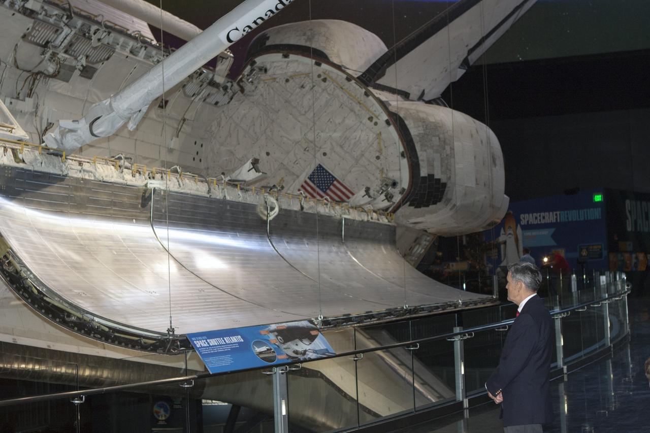 CAPE CANAVERAL, Fla. -- At the Kennedy Space Center Visitor Complex in Florida, center director Bob Cabana checks out the space shuttle Atlantis on display with other exhibits inside the new 90,000-square-foot facility.      The new $100 million facility includes interactive exhibits that tell the story of the 30-year Space Shuttle Program and highlight the future of space exploration. The "Space Shuttle Atlantis" exhibit formally opened to the public on June 29, 2013.Photo credit: NASA/Jim Grossmann