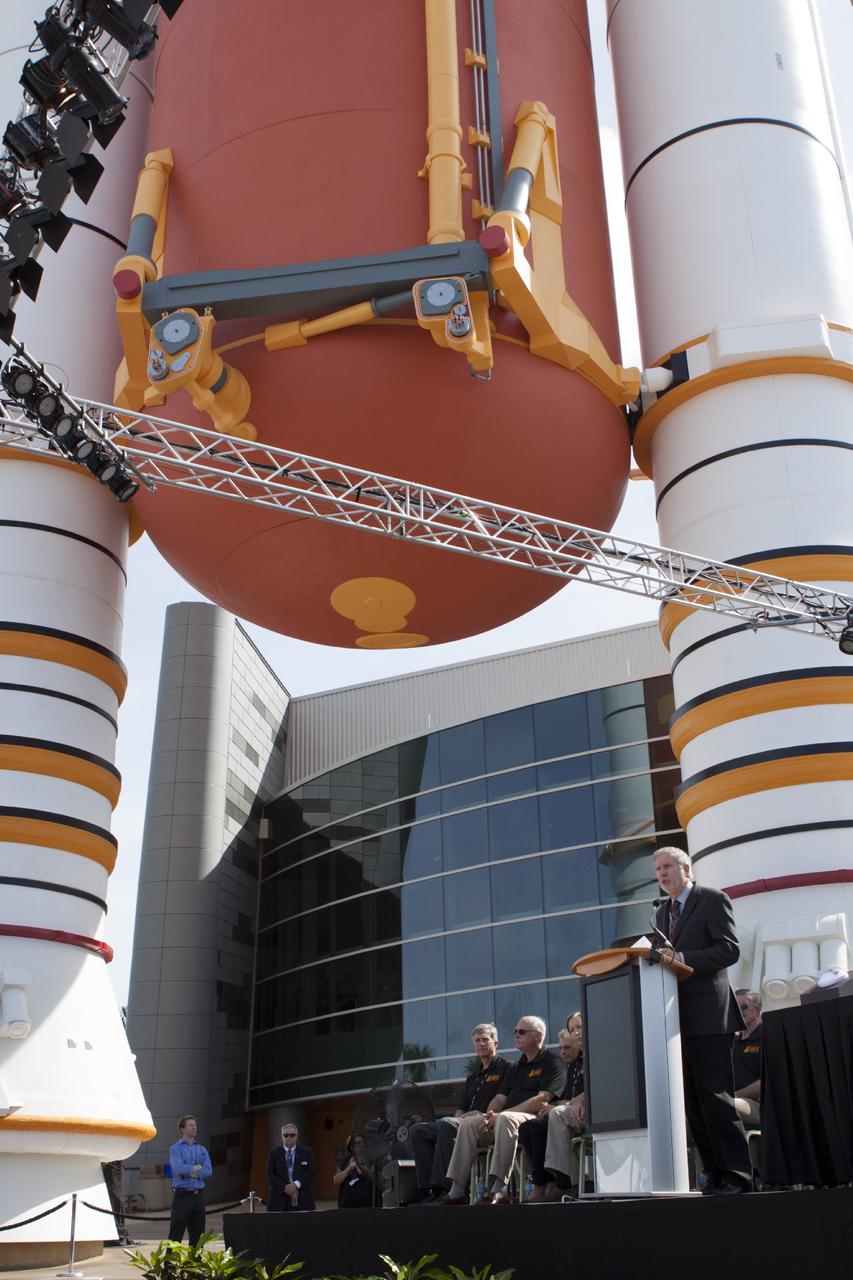 CAPE CANAVERAL, Fla. -- At the Kennedy Space Center Visitor Complex in Florida, Bill Moore, Delaware North Parks and Resorts chief operating officer speaks to guests at the opening of the new "Space Shuttle Atlantis" facility. The ceremony took place under a full-scale set of space shuttle twin solid rocket boosters and external fuel tank at the entrance to the 90,000-square-foot facility. Visitors will be able to walk beneath the 184-foot-tall boosters and tank as they enter the facility.      The new $100 million facility includes interactive exhibits that tell the story of the 30-year Space Shuttle Program and highlight the future of space exploration. The "Space Shuttle Atlantis" exhibit formally opened to the public on June 29, 2013.Photo credit: NASA/Jim Grossmann