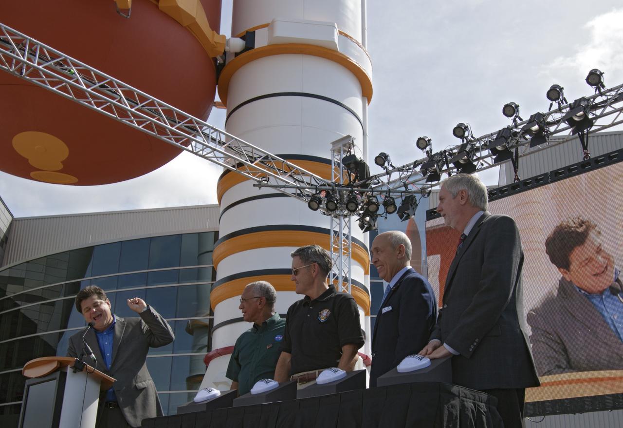 CAPE CANAVERAL, Fla. -- At the Kennedy Space Center Visitor Complex in Florida, CNN correspondent John Zarrella counts down for the ceremonial opening of the new "Space Shuttle Atlantis" facility. Ready to press buttons to mark the opening the new exhibit, from the left, are Charlie Bolden, NASA administrator, Bob Cabana, Kennedy director, Rick Abramson, Delaware North Parks and Resorts president, and Bill Moore, Delaware North Parks and Resorts chief operating officer.         The new $100 million facility includes interactive exhibits that tell the story of the 30-year Space Shuttle Program and highlight the future of space exploration. The "Space Shuttle Atlantis" exhibit formally opened to the public on June 29, 2013.Photo credit: NASA/Jim Grossmann