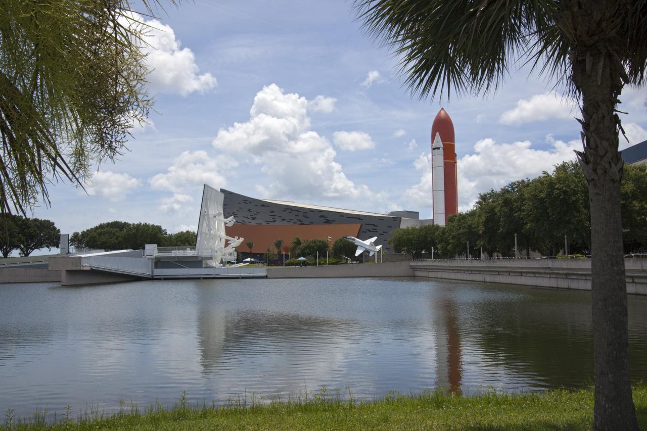 CAPE CANAVERAL, Fla. -- At the Kennedy Space Center Visitor Complex in Florida, the 90,000-square-foot "Space Shuttle Atlantis" facility has formally opened. On the right of the building, a full-scale set of space shuttle twin solid rocket boosters and external fuel tank can be seen. Standing at the entrance to the exhibit building, guests may walk beneath the 184-foot-tall boosters and tank as they enter the facility. The facility features interactive exhibits that tell the story of the 30-year Space Shuttle Program and highlights the future of space exploration.    The new $100 million facility includes interactive exhibits that tell the story of the 30-year Space Shuttle Program and highlight the future of space exploration. The "Space Shuttle Atlantis" exhibit formally opened to the public on June 29, 2013.Photo credit: NASA/Jim Grossmann