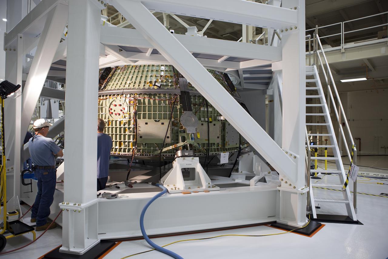CAPE CANAVERAL, Fla. -- Inside the Operations and Checkout Building high bay at NASA’s Kennedy Space Center in Florida, technicians place a hydraulic actuator in the test stand for the Orion crew module.  Lockheed Martin Space Systems and NASA engineers are preparing Orion for a series of static load tests that simulate the massive loads the spacecraft would experience during its mission.    Orion is the exploration spacecraft designed to carry crews to space beyond low Earth orbit. It will provide emergency abort capability, sustain the crew during the space travel and provide safe re-entry from deep space return velocities. Orion’s first unpiloted test flight, Exploration Flight Test 1, is scheduled to launch in 2014 atop a Delta IV rocket. A second uncrewed flight test is scheduled for 2017 on NASA’s Space Launch System rocket. For more information, visit http://www.nasa.gov/orion. Photo credit: NASA/Gary Thompson