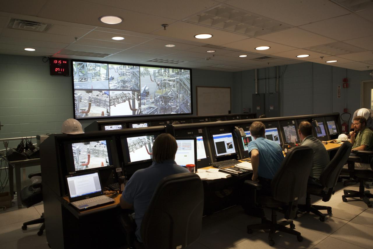 CAPE CANAVERAL, Fla. -- Engineers in a control center at the Launch Equipment Test Facility at NASA’s Kennedy Space Center in Florida monitor a test on the quick disconnect for a modified instrument unit and liquid hydrogen tilt up umbilical at the Launch Equipment Test Facility. The test is being performed by the Ground Systems Development and Operations Program. The umbilical will be partially reutilized for the Orion Service Module Unit.    Orion is the exploration spacecraft designed to carry crews to space beyond low Earth orbit. It will provide emergency abort capability, sustain the crew during the space travel and provide safe re-entry from deep space return velocities. The first unpiloted test flight of the Orion is scheduled to launch in 2014 atop a Delta IV rocket and in 2017 on a Space Launch System rocket. For more information, visit http://www.nasa.gov/orion. Photo credit: NASA/Dimitri Gerondidakis