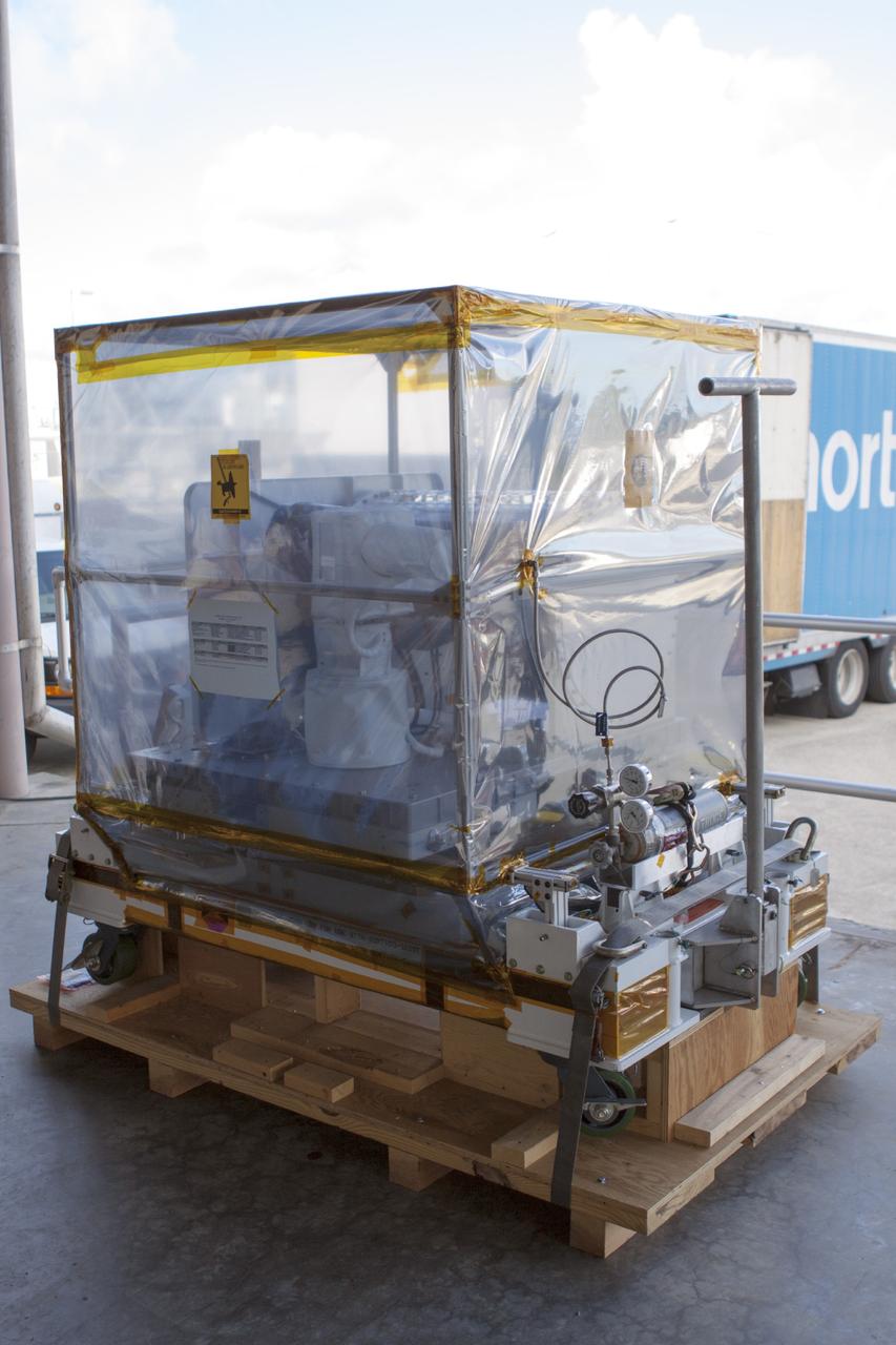 CAPE CANAVERAL, Fla. -- The Optical Payload for Lasercomm Science, or OPALS, an optical technology demonstration experiment, sits on a pallet near the Space Station Processing Facility at NASA’s Kennedy Space Center in Florida. OPALS arrived from the agency’s Jet Propulsion Laboratory in Pasadena, Calif. NASA will use the International Space Station to test OPALS’ communications technology that could dramatically improve spacecraft communications, enhance commercial missions and strengthen transmission of scientific data. The experiment is slated to fly later this year aboard a SpaceX Dragon commercial resupply mission to the space station. The mission is expected to run 90 days after installation on the outside of the station. For more information about OPALS, visit: http://go.nasa.gov/10MMPDO. Photo credit: NASA/Jim Grossmann