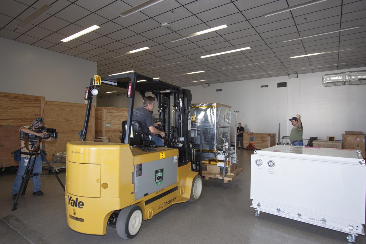 CAPE CANAVERAL, Fla. -- At NASA’s Kennedy Space Center in Florida, a technician uses a forklift to move the Optical Payload for Lasercomm Science, or OPALS, experiment to the air lock entrance at the Space Station Processing Facility. The optical technology demonstration experiment arrived from the agency’s Jet Propulsion Laboratory in Pasadena, Calif.      NASA will use the International Space Station to test OPALS’ communications technology that could dramatically improve spacecraft communications, enhance commercial missions and strengthen transmission of scientific data. The experiment is slated to fly later this year aboard a SpaceX Dragon commercial resupply mission to the space station. The mission is expected to run 90 days after installation on the outside of the station. For more information about OPALS, visit: http://go.nasa.gov/10MMPDO. Photo credit: NASA/Jim Grossmann