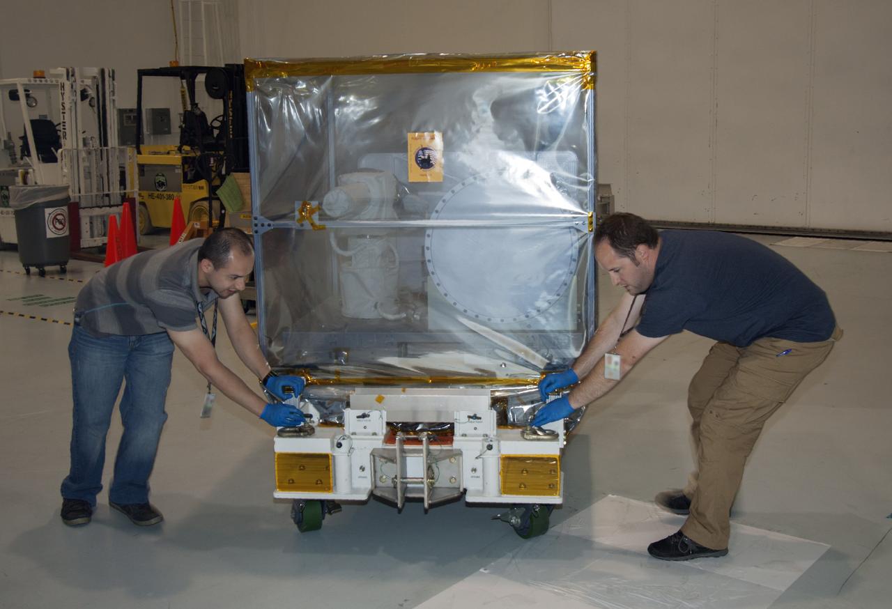 CAPE CANAVERAL, Fla. -- At NASA’s Kennedy Space Center in Florida, technicians move the Optical Payload for Lasercomm Science, or OPALS, experiment into the Space Station Processing Facility. The optical technology demonstration experiment arrived from the agency’s Jet Propulsion Laboratory in Pasadena, Calif. NASA will use the International Space Station to test OPALS’ communications technology that could dramatically improve spacecraft communications, enhance commercial missions and strengthen transmission of scientific data. The experiment is slated to fly later this year aboard a SpaceX Dragon commercial resupply mission to the space station. The mission is expected to run 90 days after installation on the outside of the station. For more information about OPALS, visit: http://go.nasa.gov/10MMPDO. Photo credit: NASA/Jim Grossmann
