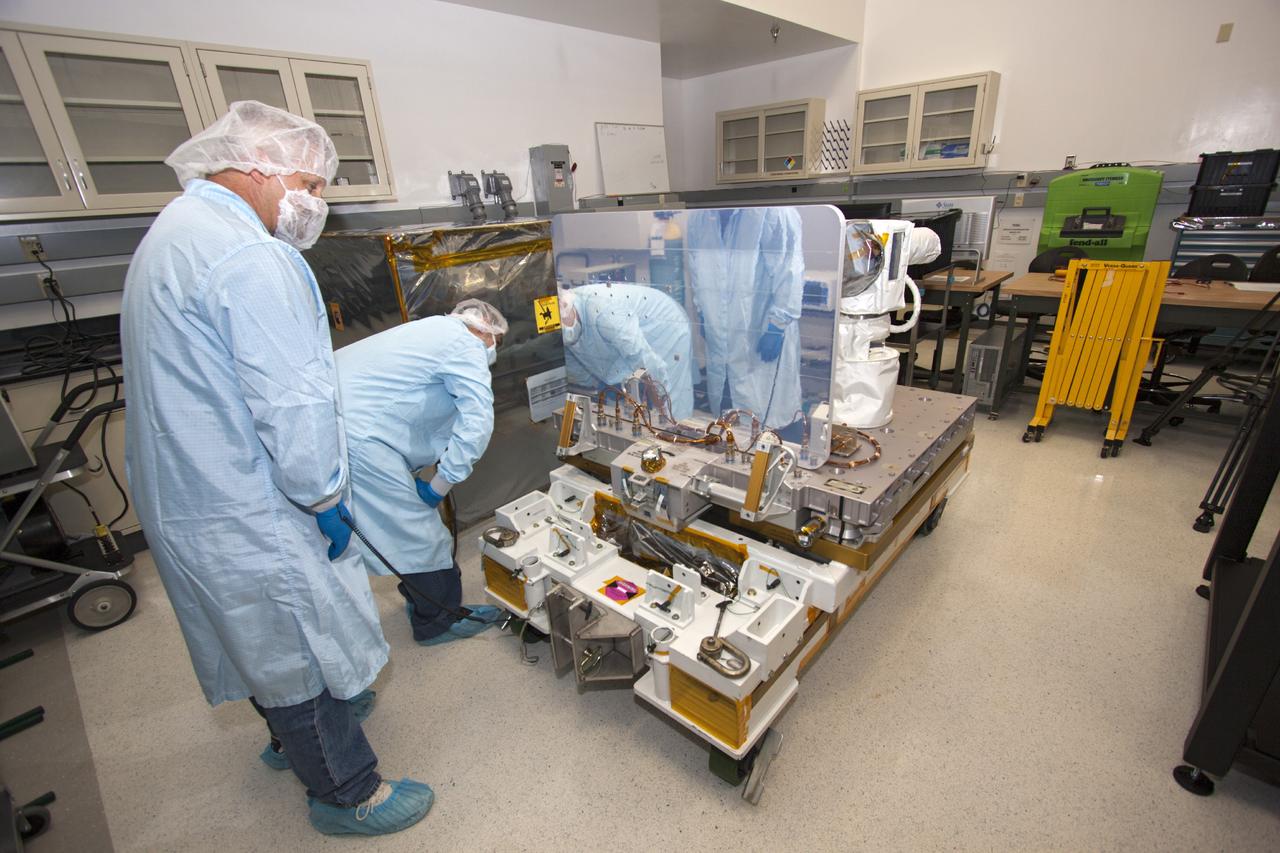 CAPE CANAVERAL, Fla. -- At NASA’s Kennedy Space Center in Florida, technicians uncover and check the Optical Payload for Lasercomm Science, or OPALS, experiment in a test cell at a Space Station Processing Facility offline laboratory. The optical technology demonstration experiment arrived from the agency’s Jet Propulsion Laboratory in Pasadena, Calif. NASA will use the International Space Station to test OPALS’ communications technology that could dramatically improve spacecraft communications, enhance commercial missions and strengthen transmission of scientific data. The experiment is slated to fly later this year aboard a SpaceX Dragon commercial resupply mission to the space station. The mission is expected to run 90 days after installation on the outside of the station. For more information about OPALS, visit: http://go.nasa.gov/10MMPDO. Photo credit: NASA/Jim Grossmann