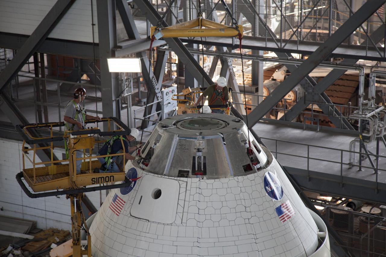 CAPE CANAVERAL, Fla. -- In the transfer aisle of the Vehicle Assembly Building at NASA’s Kennedy Space Center in Florida, crane operators and technicians practice stacking and de-stacking operations on a full-size mock-up of the Orion spacecraft and launch abort system in order to keep processing procedures and skills current for the Ground Systems Development and Operations Program. Orion is the exploration spacecraft designed to carry crews to space beyond low Earth orbit. It will provide emergency abort capability, sustain the crew during the space travel and provide safe re-entry from deep space return velocities. Orion’s first unpiloted test flight is scheduled to launch in 2014 atop a Delta IV rocket. A second uncrewed flight test is scheduled for 2017 on NASA’s Space Launch System rocket. For more information, visit http://www.nasa.gov/orion. Photo credit: NASA/Dan Casper