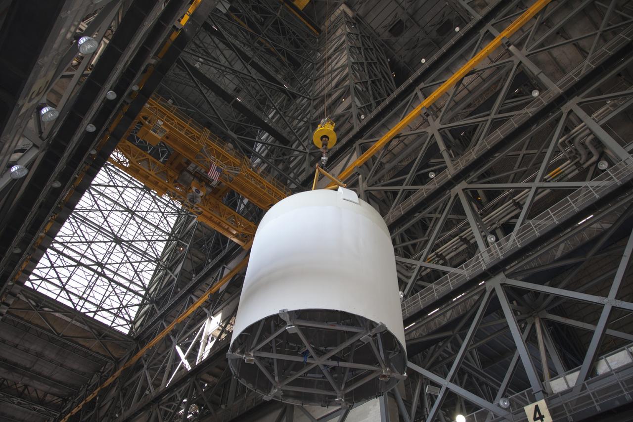 CAPE CANAVERAL, Fla. -- In the transfer aisle of the Vehicle Assembly Building at NASA’s Kennedy Space Center in Florida, a crane operator lifts a full-size mock-up of the Orion spacecraft high in the air for transfer to High Bay 4. Crane operators and technicians practice stacking and de-stacking operations in order to keep processing procedures and skills current for the Ground Systems Development and Operations Program. Orion is the exploration spacecraft designed to carry crews to space beyond low Earth orbit. It will provide emergency abort capability, sustain the crew during the space travel and provide safe re-entry from deep space return velocities. Orion’s first unpiloted test flight is scheduled to launch in 2014 atop a Delta IV rocket. A second uncrewed flight test is scheduled for 2017 on NASA’s Space Launch System rocket. For more information, visit http://www.nasa.gov/orion. Photo credit: NASA/Dan Casper