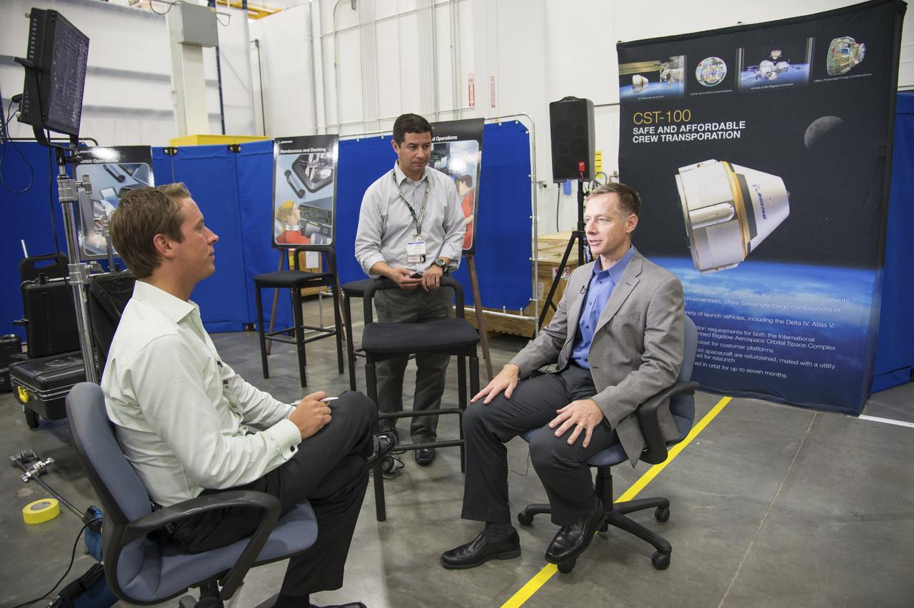 HOUSTON - JSC2013e068248 - Chris Ferguson, director of Crew and Mission Operations for The Boeing Company, is interviewed by the media during the unveiling of a CST-100 mock-up at the company's Houston Product Support Center. This test version is optimized to support five crew members and will allow the company to evaluate crew safety, interfaces, communications, maneuverability and ergonomics. Boeing's CST-100 is being designed to transport crew members or a mix of crew and cargo to low-Earth-orbit destinations, including the International Space Station. Boeing is one of three aerospace industry partners working with CCP during its Commercial Crew Integrated Capability, or CCiCap, initiative, which is intended to make commercial human spaceflight services available for government and commercial customers. To learn more about CCP, visit http://www.nasa.gov/commercialcrew. Photo credit: NASA/Robert Markowitz