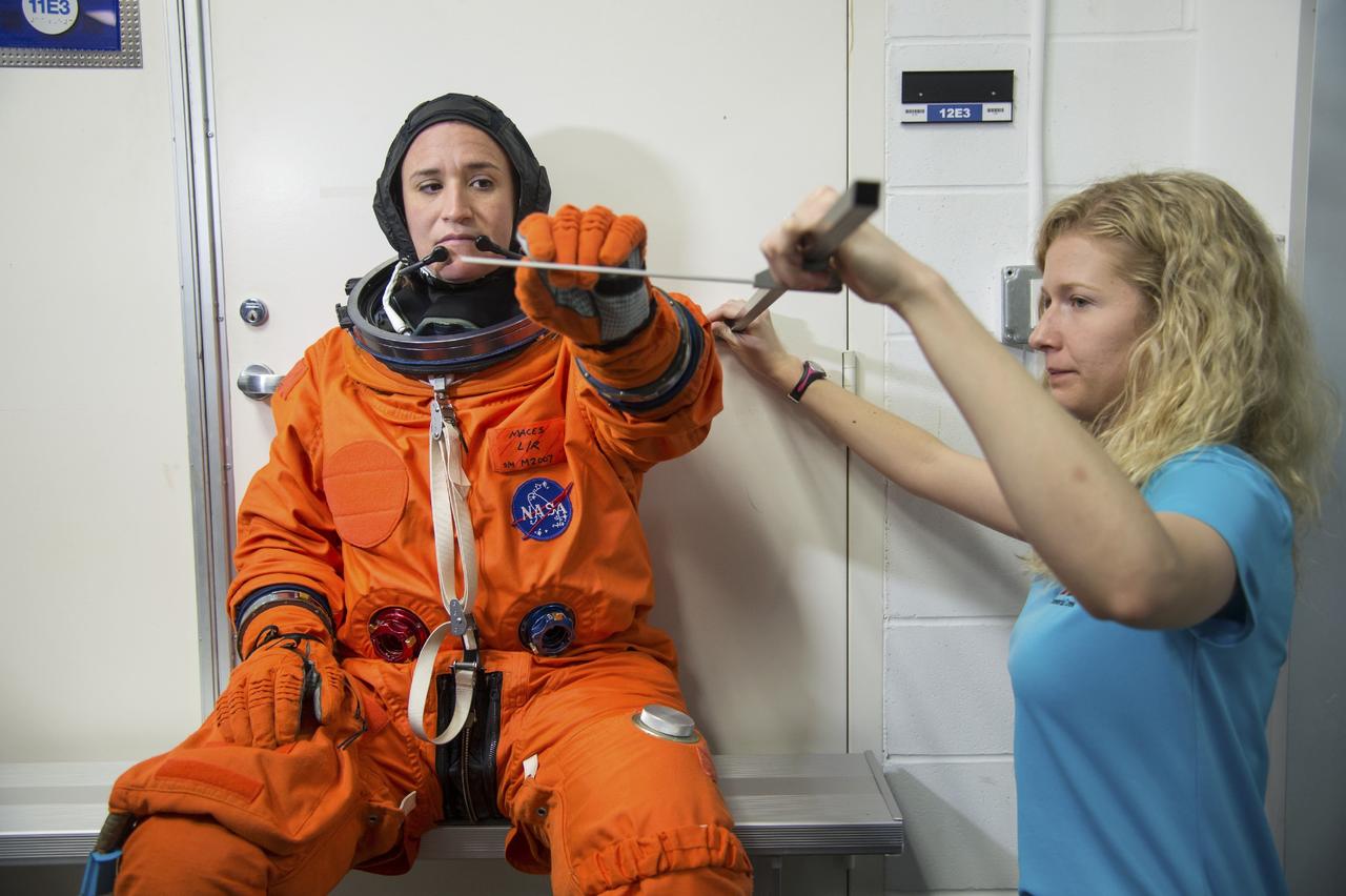 HOUSTON - JSC2013e068259 - NASA astronaut Serena Aunon prepares for a fit check evaluation of The Boeing Company's CST-100 spacecraft at the company's Houston Product Support Center. Assisting her is Andrea Gilkey, a human factors engineer with The Boeing Company. Aunon's fit check will help evaluate a crew's maneuverability in the spacecraft and test communications.      Boeing's CST-100 is being designed to transport crew members or a mix of crew and cargo to low-Earth-orbit destinations. The evaluation is part of the ongoing work supporting Boeing's funded Space Act Agreement with NASA's Commercial Crew Program, or CCP, during the agency's Commercial Crew Integrated Capability, or CCiCap, initiative. CCiCap is intended to make commercial human spaceflight services available for government and commercial customers. To learn more about CCP, visit http://www.nasa.gov/commercialcrew. Photo credit: NASA/Robert Markowitz