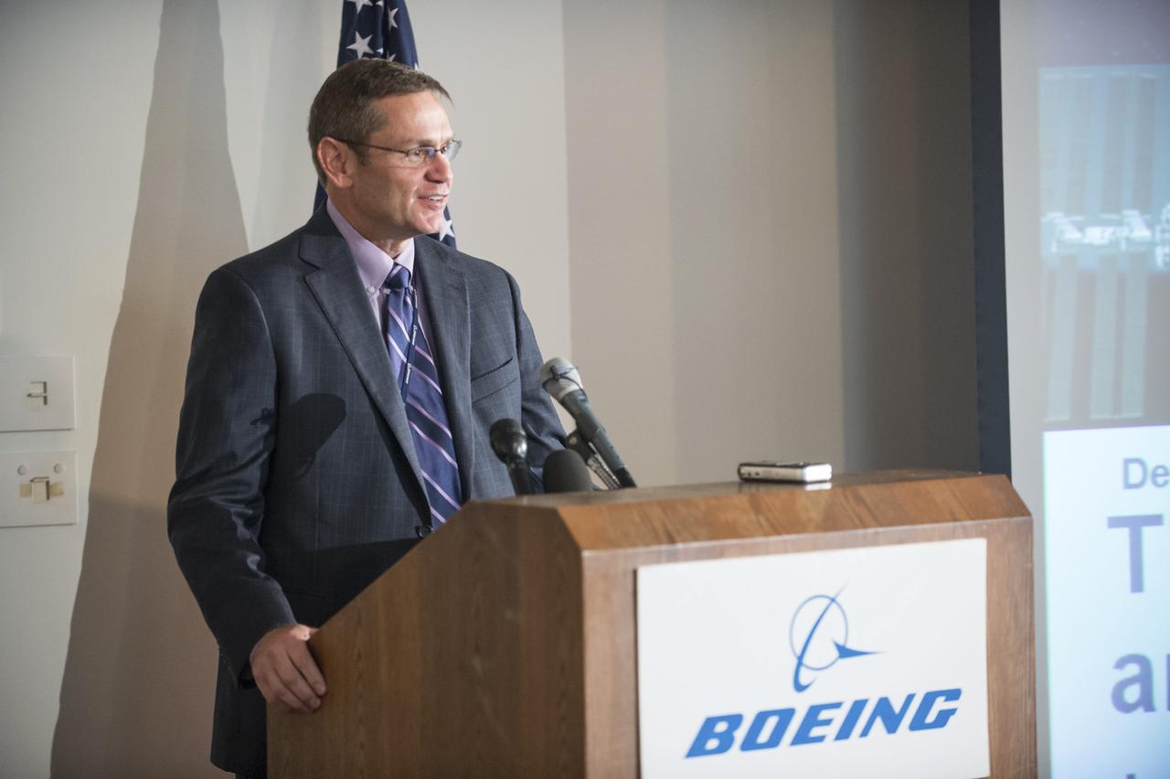 HOUSTON - JSC2013e068284 - John Elbon, vice president for Space Exploration for The Boeing Company, addresses the media before the unveiling of a CST-100 mock-up at the company's Houston Product Support Center. This test version is optimized to support five crew members and will allow the company to evaluate crew safety, interfaces, communications, maneuverability and ergonomics. Boeing's CST-100 is being designed to transport crew members or a mix of crew and cargo to low-Earth-orbit destinations. The evaluation is part of the ongoing work supporting Boeing's funded Space Act Agreement with NASA's Commercial Crew Program, or CCP, during the agency's Commercial Crew Integrated Capability, or CCiCap, initiative. CCiCap is intended to make commercial human spaceflight services available for government and commercial customers. To learn more about CCP, visit http://www.nasa.gov/commercialcrew. Photo credit: NASA/Robert Markowitz