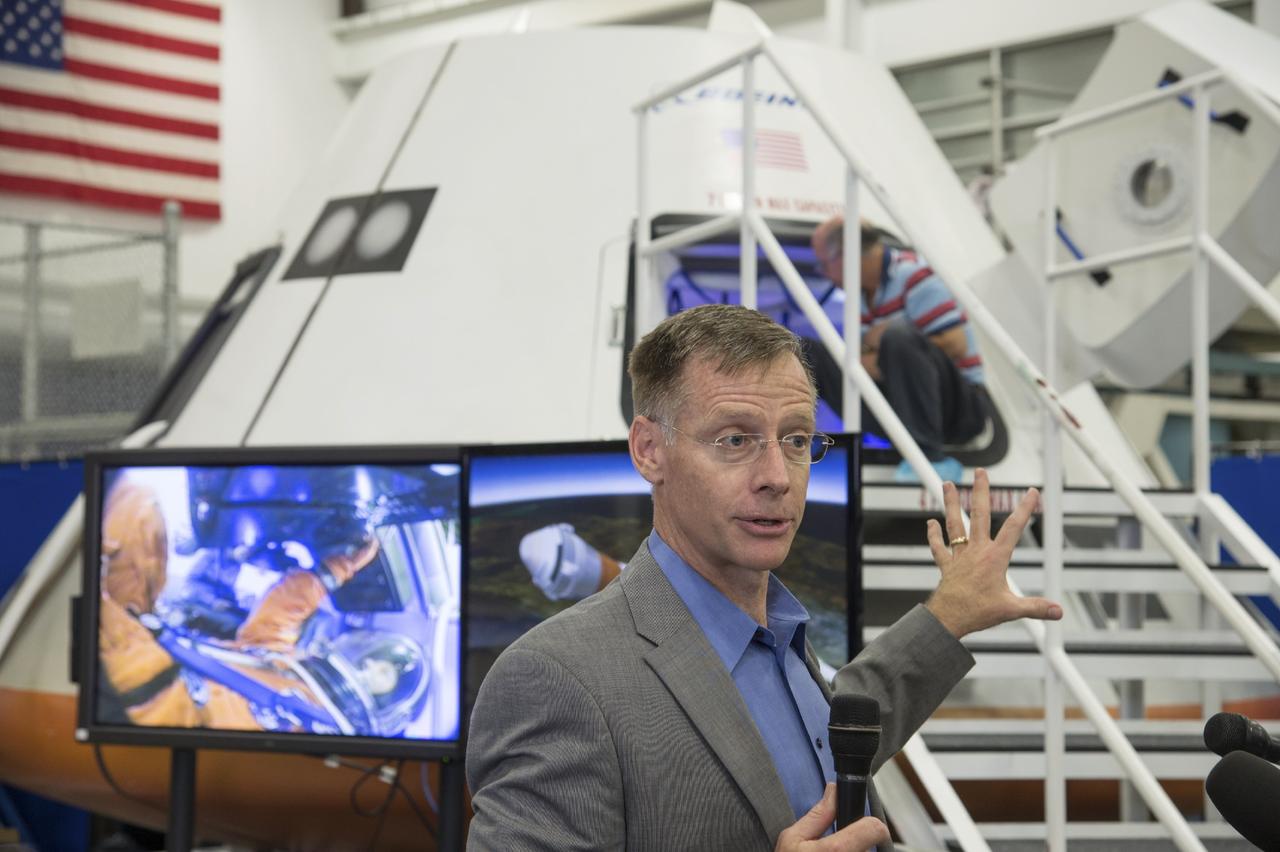 HOUSTON - JSC2013e068310 - Chris Ferguson, director of Crew and Mission Operations for The Boeing Company and former NASA astronaut, discusses the fit check evaluation of the CST-100 mock-up with the media during its unveiling at the company's Houston Product Support Center. This test version is optimized to support five crew members and will allow the company to evaluate crew safety, interfaces, communications, maneuverability and ergonomics. Boeing's CST-100 is being designed to transport crew members or a mix of crew and cargo to low-Earth-orbit destinations. The evaluation is part of the ongoing work supporting Boeing's funded Space Act Agreement with NASA's Commercial Crew Program, or CCP, during the agency's Commercial Crew Integrated Capability, or CCiCap, initiative. CCiCap is intended to make commercial human spaceflight services available for government and commercial customers. To learn more about CCP, visit http://www.nasa.gov/commercialcrew. Photo credit: NASA/Robert Markowitz