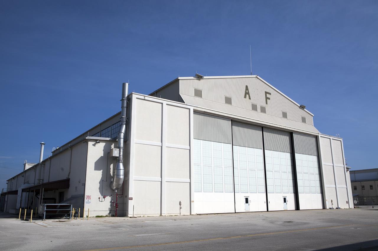 CAPE CANAVERAL, Fla. – An exterior view of Hangar AF at Cape Canaveral Air Force Station in Florida. The facility may be used by the Ground Systems Development and Operations Program at Kennedy Space Center for production activities for NASA’s Space Launch System, or SLS. The booster aft and forward skirts and case stiffener attach ring may be processed in the hangar, as well as refurbishment of the frustrum, before they are transferred to the Booster Fabrication Facility for buildup.    The SLS rocket will launch the Orion spacecraft on an uncrewed flight test scheduled for 2017. Orion ’s first unpiloted test flight, Exploration Flight Test 1, is scheduled to launch in 2014 atop a Delta IV rocket. For more information, visit http://www.nasa.gov/orion. Photo credit: NASA/Dimitri Gerondidakis