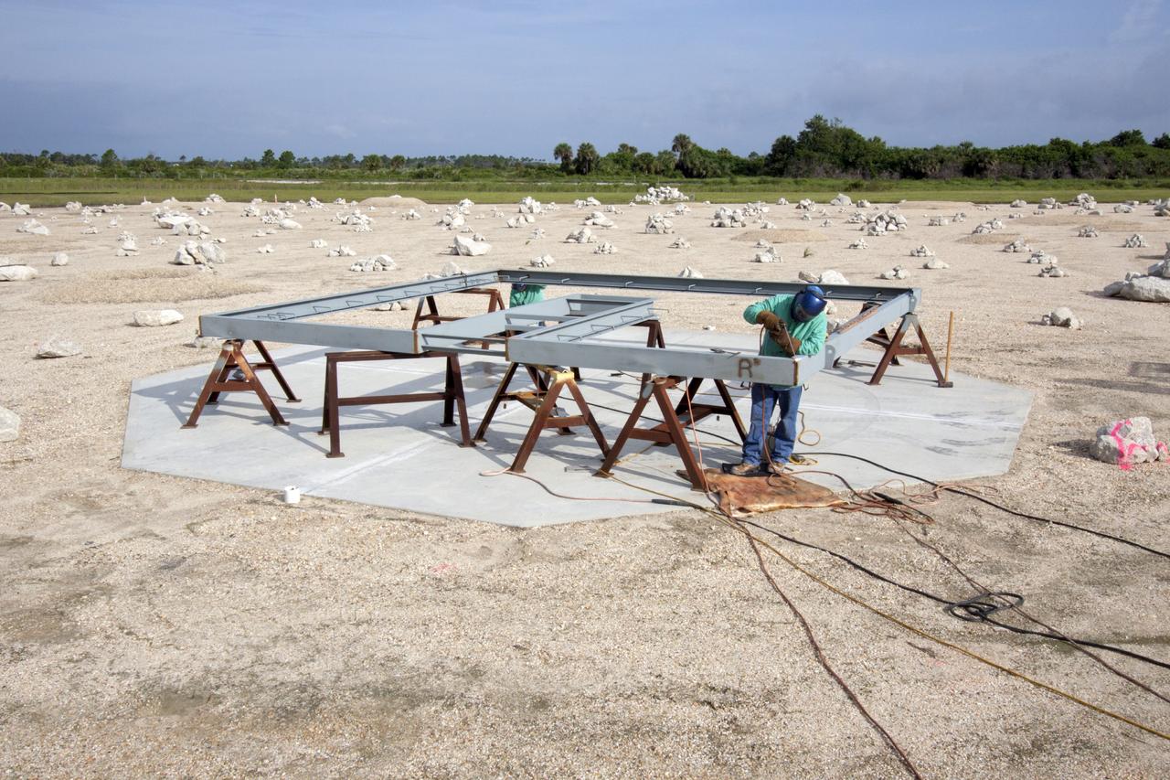 CAPE CANAVERAL, Fla. – At NASA’s Kennedy Space Center in Florida, a technician works on the buildup of a movable launch platform for the Project Morpheus lander at the midfield of the Shuttle Landing Facility, or SLF. Testing of the prototype lander has been ongoing at NASA’s Johnson Space Center in Houston in preparation for free flight. The SLF will provide the lander with the kind of field necessary for realistic testing, complete with rocks, craters and hazards to avoid. Morpheus utilizes an autonomous landing and hazard avoidance technology, or ALHAT, payload that will allow it to navigate to clear landing sites amidst rocks, craters and other hazards during its descent. Project Morpheus is one of 20 small projects comprising the Advanced Exploration Systems, or AES, program in NASA’s Human Exploration and Operations Mission Directorate. AES projects pioneer new approaches for rapidly developing prototype systems, demonstrating key capabilities and validating operational concepts for future human missions beyond Earth orbit. For more information on Project Morpheus, visit http://www.nasa.gov/centers/johnson/exploration/morpheus/index.html. Photo credit: NASA/Jim Grossmann