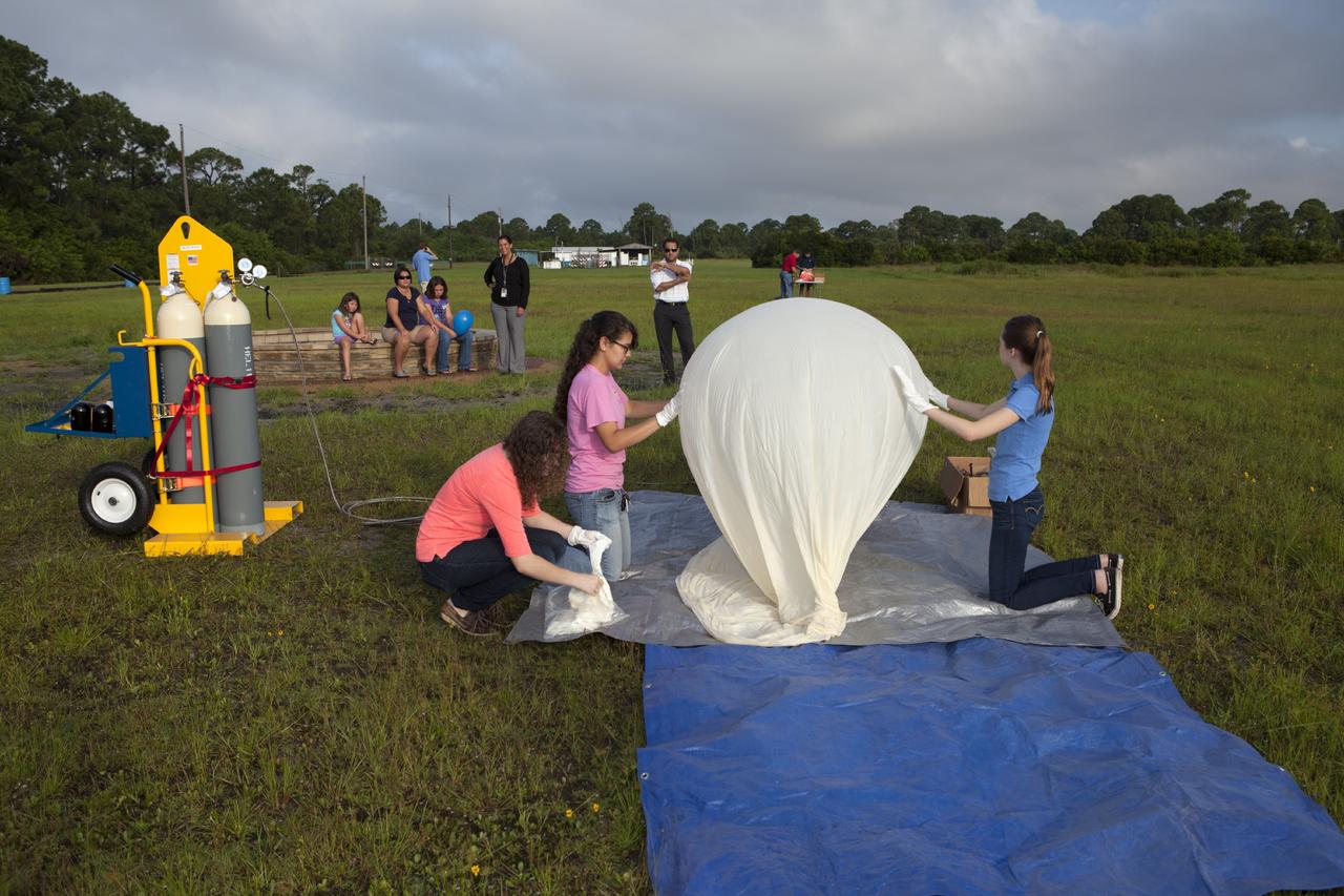 CAPE CANAVERAL, Fla. – Rocket University participants fill a high-altitude balloon before releasing it to carry an instrument package as part of an aerial experiment by the program. The balloon was released at Kennedy Space Center and its instrument package was recovered to the southeast as planned. Photo credit: NASA/Dmitri Gerondidakis