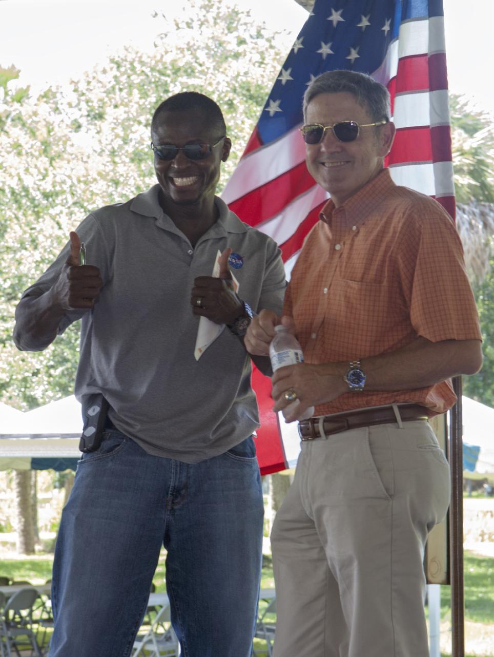 Merritt Island, Fla. – Kennedy Space Center worker Yves Lamothe and Center Director Bob Cabana welcome guests to the 2013 Black Employee Strategy Team BEST  BBQ at KARS Park I on Merritt Island. Events included a noncompetitive car show and a spades tournament. BEST hosts the barbecue as a fundraiser for the Evelyn Johnson Scholarship, which is handed out every year to students who exemplify significant achievement both academically and in their community. The scholarship is in honor of Evelyn Johnson, a founding member of BEST and former deputy director of Kennedy’s Diversity and Equal Opportunity Office. Photo credit: NASA/ Charisse Nahser