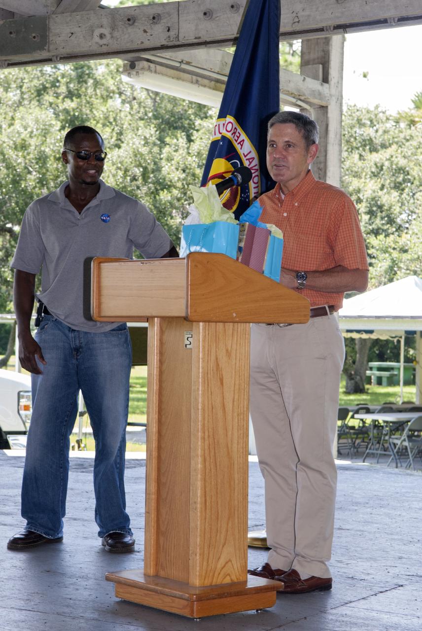Merritt Island, Fla. – Kennedy Space Center worker Yves Lamothe and Center Director Bob Cabana welcome guests to the 2013 Black Employee Strategy Team BEST  BBQ at KARS Park I on Merritt Island. Events included a noncompetitive car show and a spades tournament. BEST hosts the barbecue as a fundraiser for the Evelyn Johnson Scholarship, which is handed out every year to students who exemplify significant achievement both academically and in their community. The scholarship is in honor of Evelyn Johnson, a founding member of BEST and former deputy director of Kennedy’s Diversity and Equal Opportunity Office. Photo credit: NASA/ Charisse Nahser