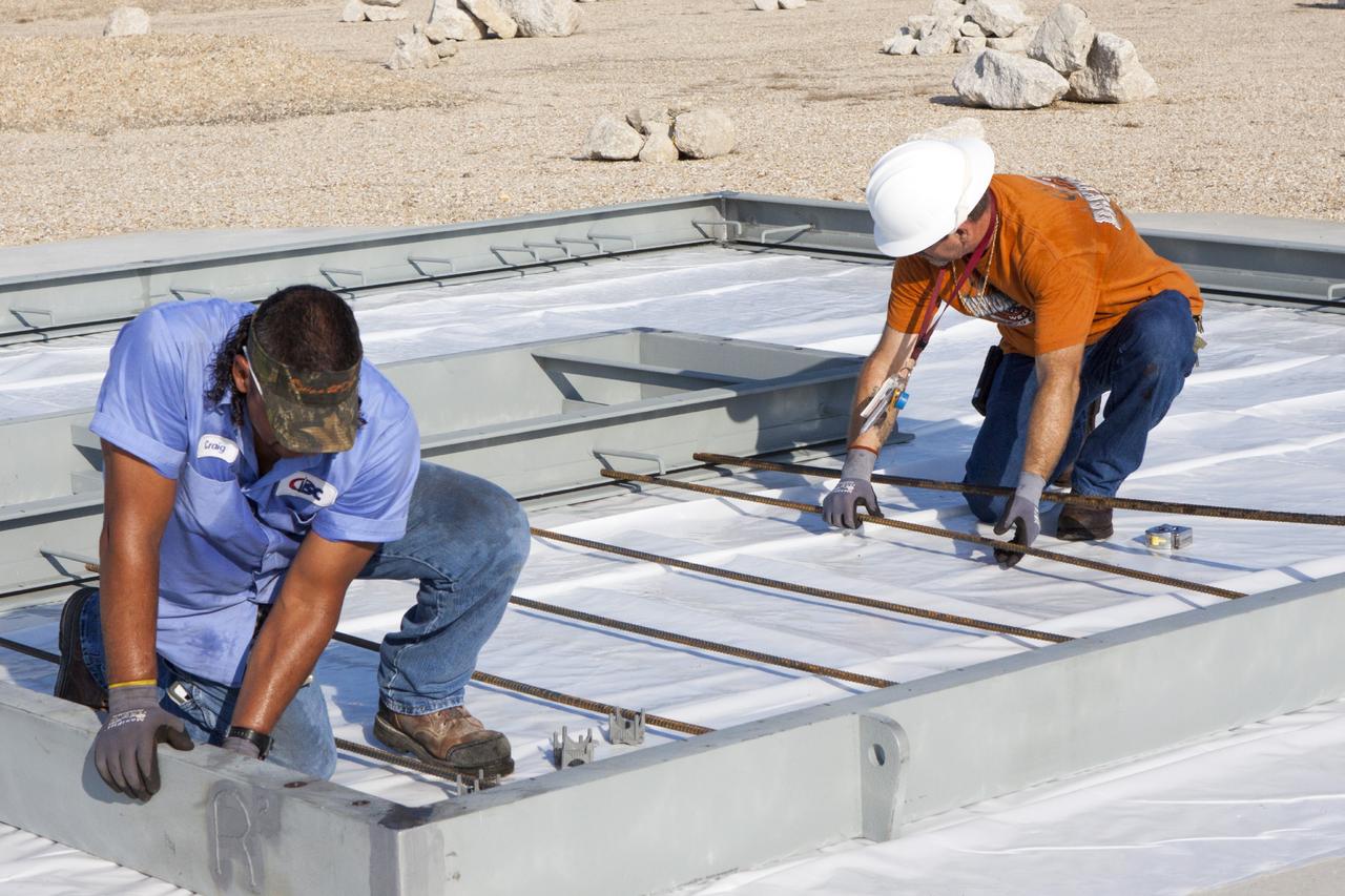 CAPE CANAVERAL, Fla. – At NASA’s Kennedy Space Center in Florida, technicians work on the buildup of a movable launch platform for the Project Morpheus lander at the Shuttle Landing Facility, or SLF. Testing of the prototype lander has been ongoing at NASA’s Johnson Space Center in Houston in preparation for free flight. The SLF will provide the lander with the kind of field necessary for realistic testing, complete with rocks, craters and hazards to avoid. Morpheus utilizes an autonomous landing and hazard avoidance technology, or ALHAT, payload that will allow it to navigate to clear landing sites amidst rocks, craters and other hazards during its descent. Project Morpheus is one of 20 small projects comprising the Advanced Exploration Systems, or AES, program in NASA’s Human Exploration and Operations Mission Directorate. AES projects pioneer new approaches for rapidly developing prototype systems, demonstrating key capabilities and validating operational concepts for future human missions beyond Earth orbit. For more information on Project Morpheus, visit http://www.nasa.gov/centers/johnson/exploration/morpheus/index.html. Photo credit: NASA/Jim Grossmann