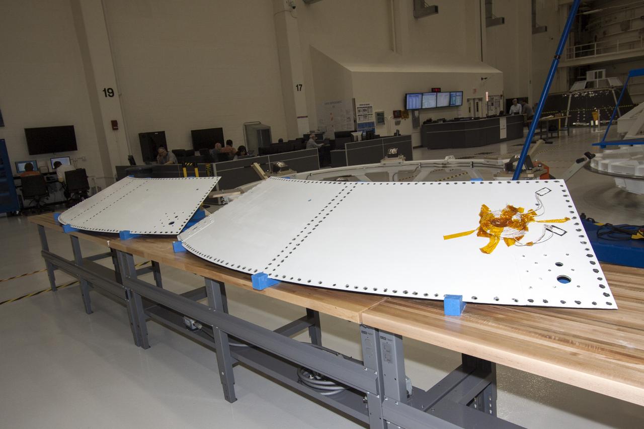 CAPE CANAVERAL, Fla. – Inside the Operations and Checkout Building high bay at NASA’s Kennedy Space Center in Florida, components of the Orion service module composite panel aft walls have been secured on work stands for processing.    Orion is the exploration spacecraft designed to carry crews to space beyond low Earth orbit. It will provide emergency abort capability, sustain the crew during the space travel and provide safe re-entry from deep space return velocities. The first unpiloted test flight of the Orion is scheduled to launch in 2014 atop a Delta IV rocket and in 2017 on a Space Launch System rocket. For more information, visit http://www.nasa.gov/orion. Photo credit: NASA/Jim Grossmann