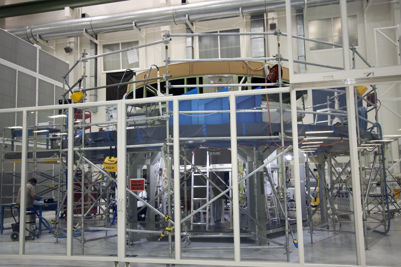 CAPE CANAVERAL, Fla. – The Orion crew module for Exploration Flight Test 1 sits inside a clean room processing cell in the Operations and Checkout Building high bay at NASA’s Kennedy Space Center in Florida.     Orion is the exploration spacecraft designed to carry crews to space beyond low Earth orbit. It will provide emergency abort capability, sustain the crew during the space travel and provide safe re-entry from deep space return velocities. The first unpiloted test flight of the Orion is scheduled to launch in 2014 atop a Delta IV rocket and in 2017 on a Space Launch System rocket. For more information, visit http://www.nasa.gov/orion. Photo credit: NASA/Jim Grossmann