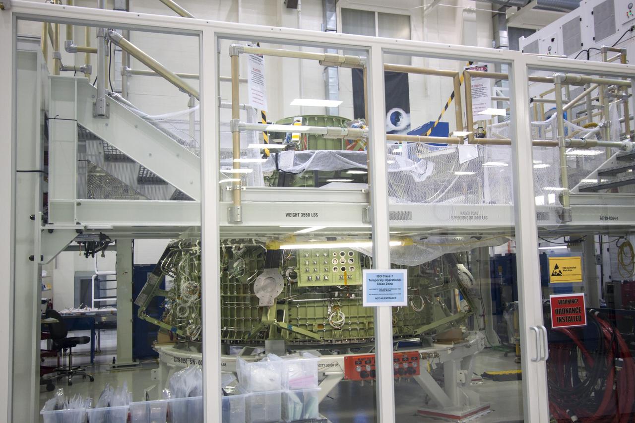 CAPE CANAVERAL, Fla. – The Orion crew module for Exploration Flight Test 1 sits inside a clean room processing cell in the Operations and Checkout Building high bay at NASA’s Kennedy Space Center in Florida.     Orion is the exploration spacecraft designed to carry crews to space beyond low Earth orbit. It will provide emergency abort capability, sustain the crew during the space travel and provide safe re-entry from deep space return velocities. The first unpiloted test flight of the Orion is scheduled to launch in 2014 atop a Delta IV rocket and in 2017 on a Space Launch System rocket. For more information, visit http://www.nasa.gov/orion. Photo credit: NASA/Jim Grossmann