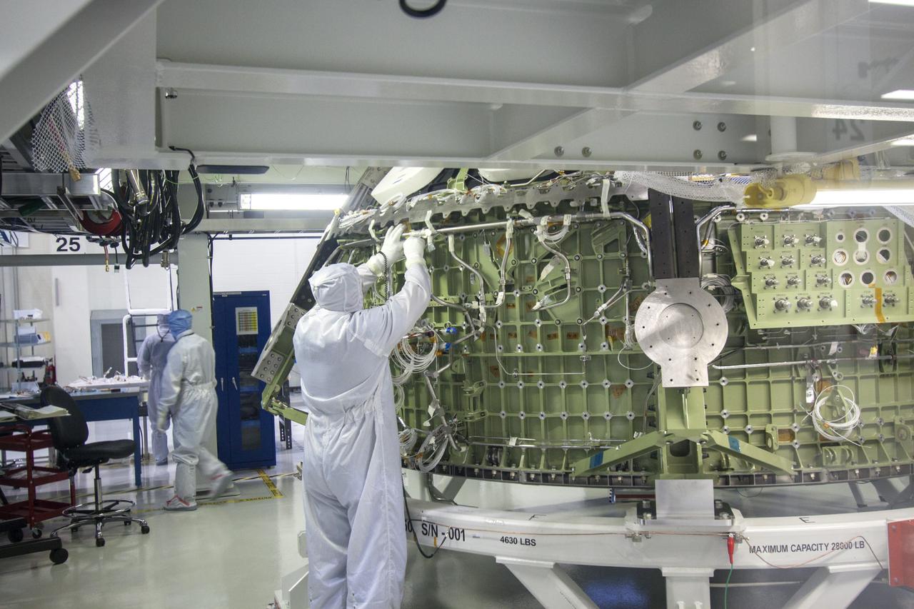 CAPE CANAVERAL, Fla. – A Lockheed Martin technician performs tube welding on the Orion crew module for Exploration Flight Test 1 inside a clean room processing cell in the Operations and Checkout Building high bay at NASA’s Kennedy Space Center in Florida.     Orion is the exploration spacecraft designed to carry crews to space beyond low Earth orbit. It will provide emergency abort capability, sustain the crew during the space travel and provide safe re-entry from deep space return velocities. The first unpiloted test flight of the Orion is scheduled to launch in 2014 atop a Delta IV rocket and in 2017 on a Space Launch System rocket. For more information, visit http://www.nasa.gov/orion. Photo credit: NASA/Jim Grossmann