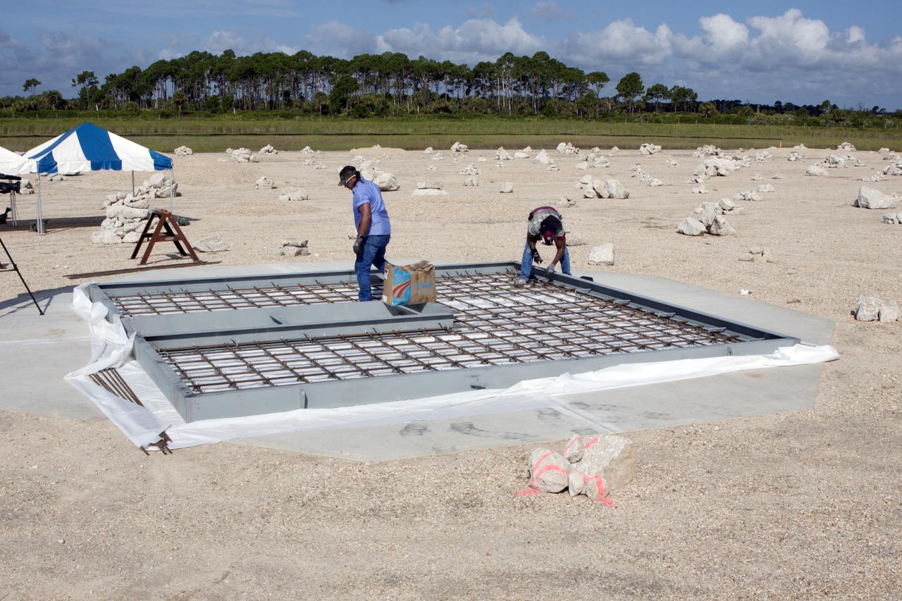 CAPE CANAVERAL, Fla. – At NASA’s Kennedy Space Center in Florida, technicians continue to work on the buildup of a movable launch platform for the Project Morpheus lander at the north end of the Shuttle Landing Facility, or SLF. Testing of the prototype lander has been ongoing at NASA’s Johnson Space Center in Houston in preparation for free flight. The SLF will provide the lander with the kind of field necessary for realistic testing, complete with rocks, craters and hazards to avoid. Morpheus utilizes an autonomous landing and hazard avoidance technology, or ALHAT, payload that will allow it to navigate to clear landing sites amidst rocks, craters and other hazards during its descent. Project Morpheus is one of 20 small projects comprising the Advanced Exploration Systems, or AES, program in NASA’s Human Exploration and Operations Mission Directorate. AES projects pioneer new approaches for rapidly developing prototype systems, demonstrating key capabilities and validating operational concepts for future human missions beyond Earth orbit. For more information on Project Morpheus, visit http://www.nasa.gov/centers/johnson/exploration/morpheus/index.html. Photo credit: NASA/Jim Grossmann