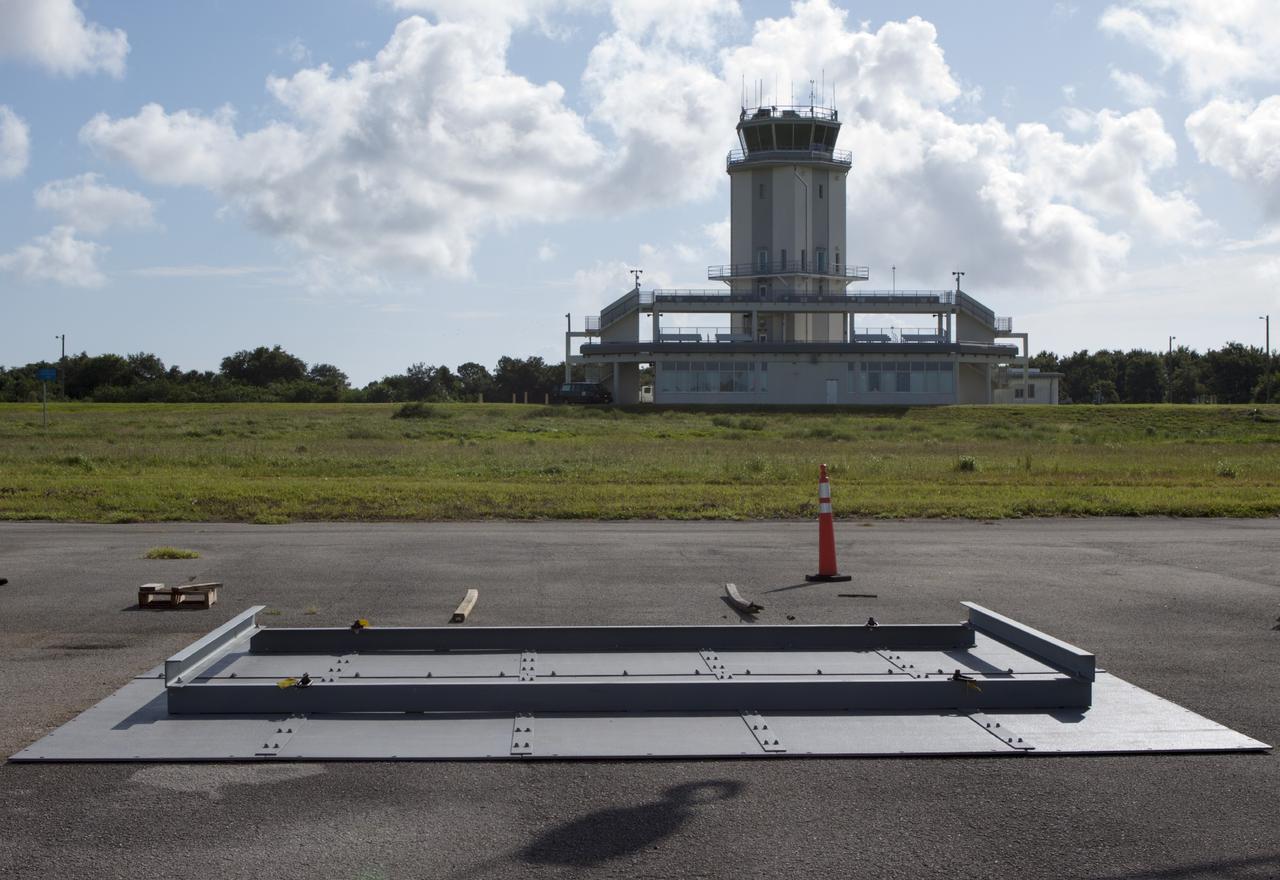 CAPE CANAVERAL, Fla. – At NASA’s Kennedy Space Center in Florida, buildup continues on the metal landing pad for the Project Morpheus lander at the midfield of the Shuttle Landing Facility, or SLF. Testing of the prototype lander has been ongoing at NASA’s Johnson Space Center in Houston in preparation for free flight. The SLF will provide the lander with the kind of field necessary for realistic testing, complete with rocks, craters and hazards to avoid. Morpheus utilizes an autonomous landing and hazard avoidance technology, or ALHAT, payload that will allow it to navigate to clear landing sites amidst rocks, craters and other hazards during its descent. Project Morpheus is one of 20 small projects comprising the Advanced Exploration Systems, or AES, program in NASA’s Human Exploration and Operations Mission Directorate. AES projects pioneer new approaches for rapidly developing prototype systems, demonstrating key capabilities and validating operational concepts for future human missions beyond Earth orbit. For more information on Project Morpheus, visit http://www.nasa.gov/centers/johnson/exploration/morpheus/index.html. Photo credit: NASA/Jim Grossmann