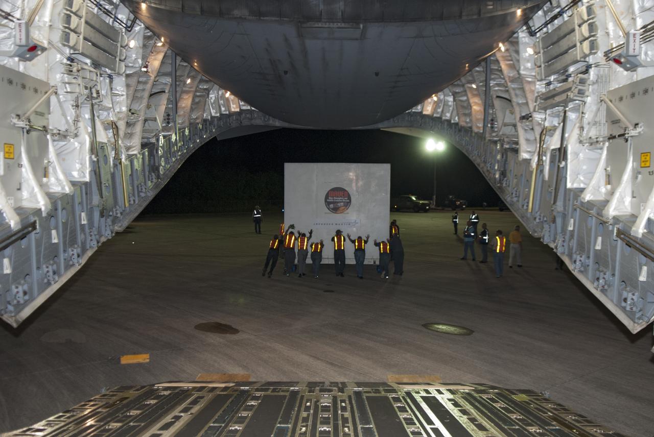 CAPE CANAVERAL, Fla. – Technicians guide the MAVEN spacecraft as it is offloaded from a C-17 aircraft at NASA's Kennedy Space Center in Florida. The aircraft delivered MAVEN for processing ahead of a launch later this year on a United Launch Alliance Atlas V rocket. MAVEN, short for Mars Atmosphere and Volatile Evolution, will orbit Mars to study the Red Planet's upper atmosphere in unprecedented detail. Photo credit: NASA/Tim Jacobs