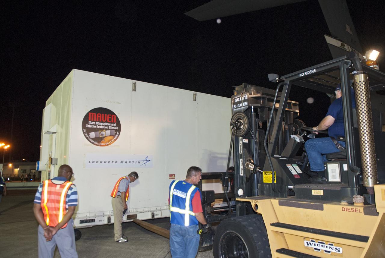 CAPE CANAVERAL, Fla. – At NASA's Kennedy Space Center in Florida, the MAVEN spacecraft, still in its shipping container, is picked up by a forklift at the Shuttle Landing Facility following offload from a C-17 aircraft. The aircraft delivered MAVEN for processing ahead of a launch later this year on a United Launch Alliance Atlas V rocket.    MAVEN, short for Mars Atmosphere and Volatile Evolution, will orbit Mars to study the Red Planet's upper atmosphere in unprecedented detail. Photo credit: NASA/Tim Jacobs