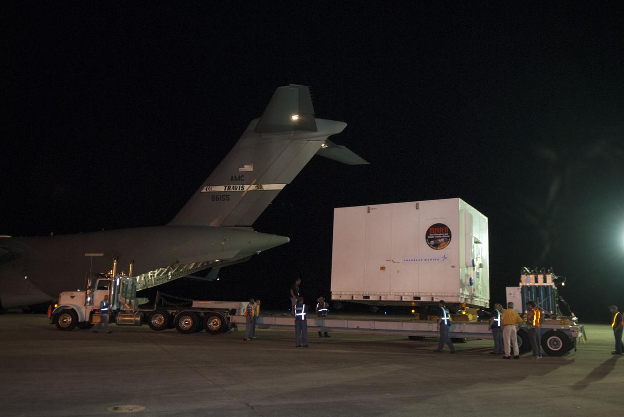 CAPE CANAVERAL, Fla. – At NASA's Kennedy Space Center in Florida, the MAVEN spacecraft, still in its shipping container, is lifted onto a truck following offload from a C-17 aircraft. The aircraft delivered MAVEN for processing ahead of a launch later this year on a United Launch Alliance Atlas V rocket. MAVEN, short for Mars Atmosphere and Volatile Evolution, will orbit Mars to study the Red Planet's upper atmosphere in unprecedented detail. Photo credit: NASA/Tim Jacobs