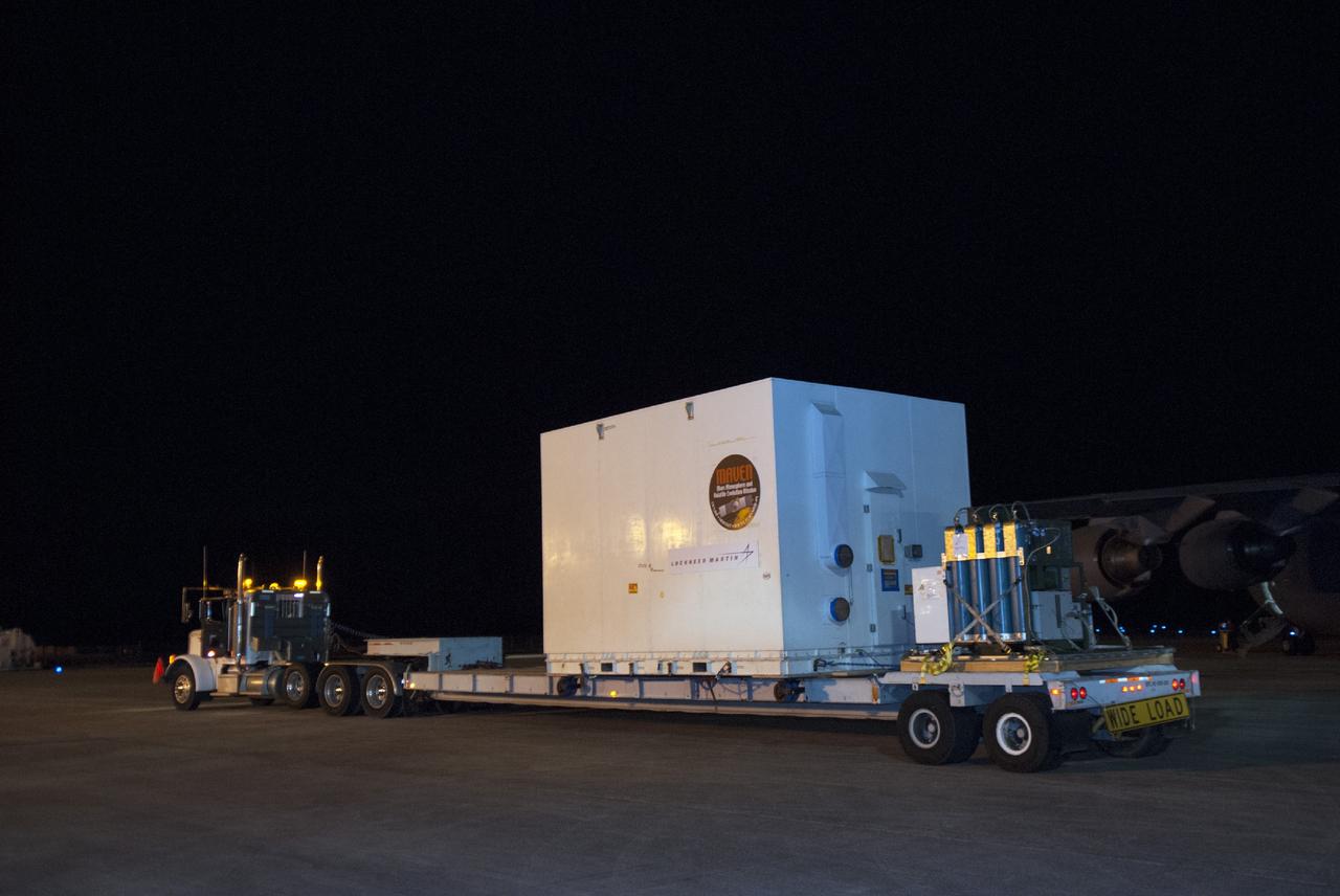 CAPE CANAVERAL, Fla. – The shipping container carrying the MAVEN spacecraft departs the Shuttle Landing Facility at NASA's Kennedy Space Center in Florida. A C-17 aircraft delivered MAVEN for processing ahead of a launch later this year on a United Launch Alliance Atlas V rocket. MAVEN, short for Mars Atmosphere and Volatile Evolution, will orbit Mars to study the Red Planet's upper atmosphere in unprecedented detail. Photo credit: NASA/Tim Jacobs