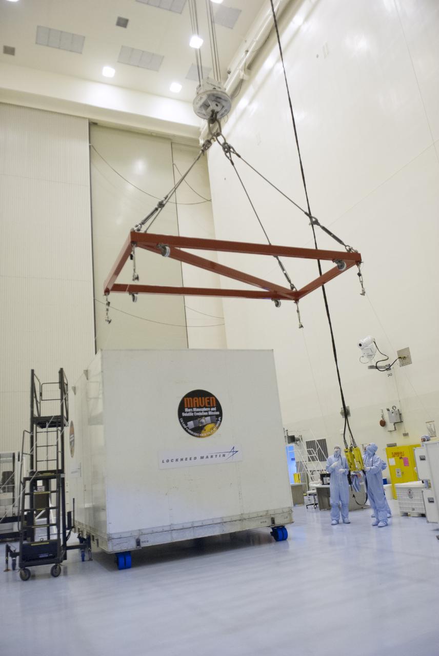 CAPE CANAVERAL, Fla. – Engineers move a sling into place for the removal of a shipping container from around NASA’s Mars Atmosphere and Volatile Evolution MAVEN spacecraft inside the Payload Hazardous Servicing Facility on Aug. 3, 2013, at the agency’s Kennedy Space Center in Florida. MAVEN will be prepared inside the facility for its scheduled November launch to Mars. Positioned in an orbit above the Red Planet, MAVEN will study the upper atmosphere of Mars in unprecedented detail. Photo credit: NASA/Tim Jacobs