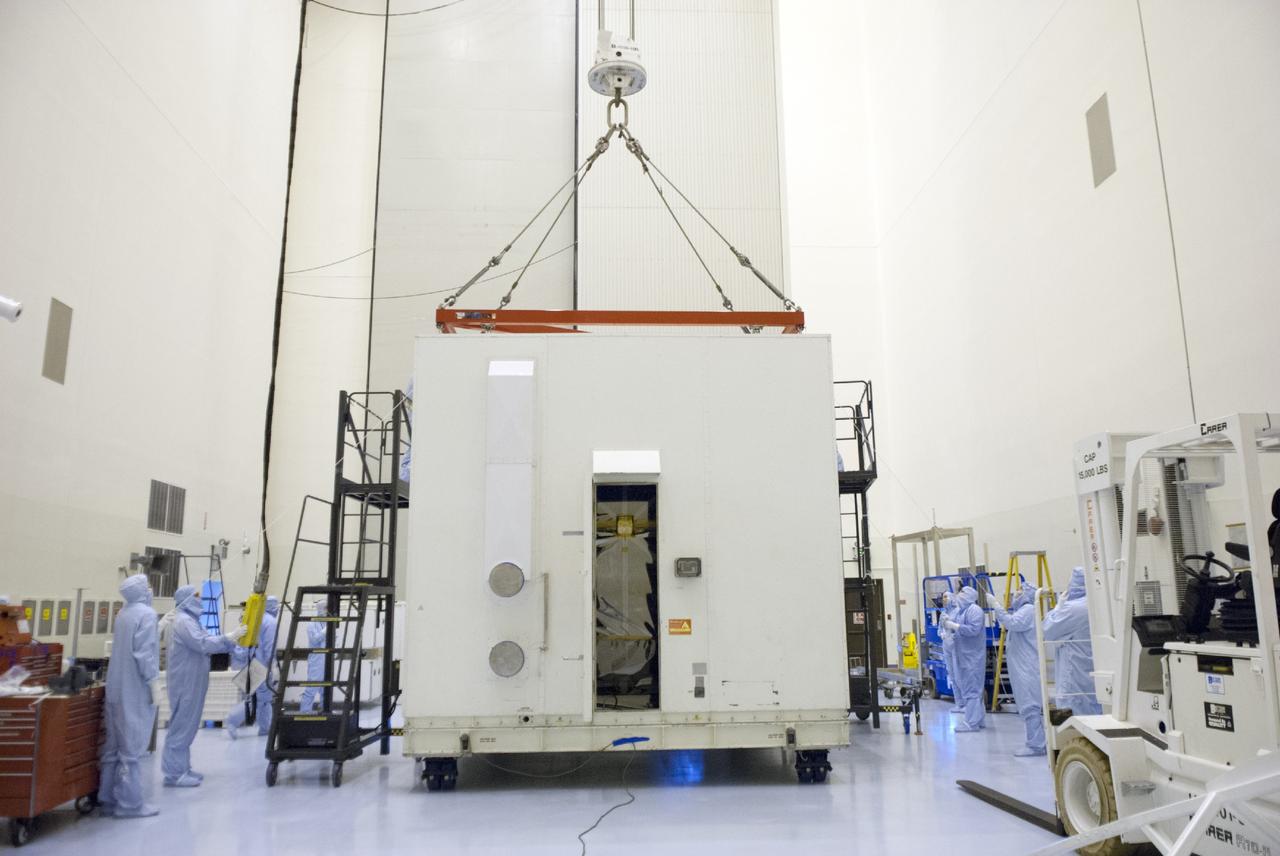 CAPE CANAVERAL, Fla. – Engineers use a sling to remove a shipping container from around NASA’s Mars Atmosphere and Volatile Evolution MAVEN spacecraft inside the Payload Hazardous Servicing Facility on Aug. 3, 2013, at the agency’s Kennedy Space Center in Florida. MAVEN will be prepared inside the facility for its scheduled November launch to Mars. Positioned in an orbit above the Red Planet, MAVEN will study the upper atmosphere of Mars in unprecedented detail. Photo credit: NASA/Tim Jacobs