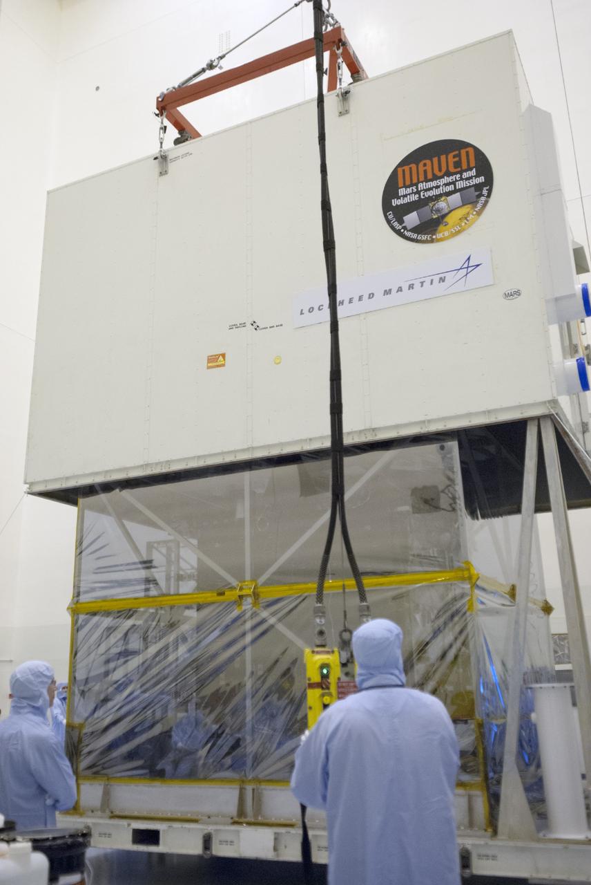 CAPE CANAVERAL, Fla. – Engineers use a sling to remove a shipping container from around NASA’s Mars Atmosphere and Volatile Evolution MAVEN spacecraft inside the Payload Hazardous Servicing Facility on Aug. 3, 2013, at the agency’s Kennedy Space Center in Florida. MAVEN will be prepared inside the facility for its scheduled November launch to Mars. Positioned in an orbit above the Red Planet, MAVEN will study the upper atmosphere of Mars in unprecedented detail. Photo credit: NASA/Tim Jacobs