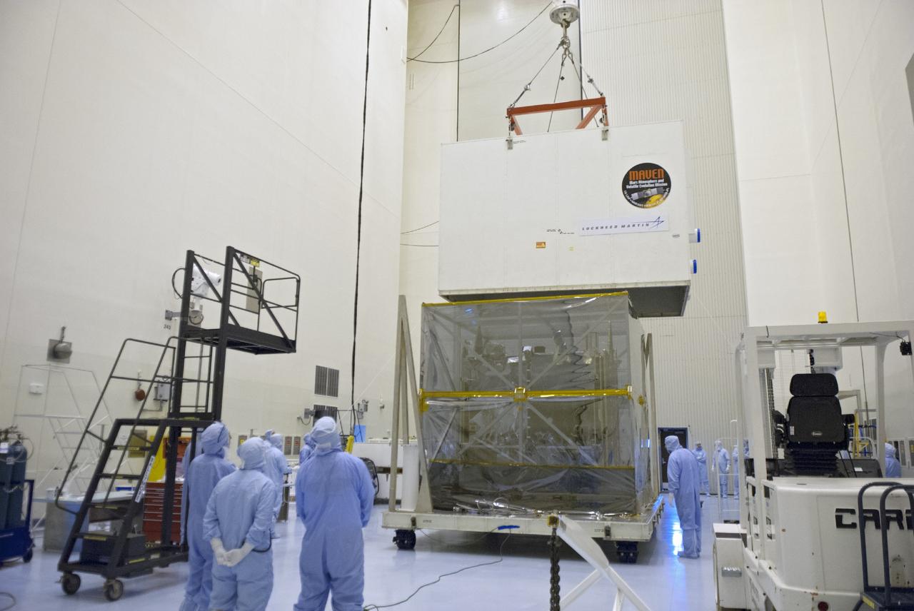 CAPE CANAVERAL, Fla. – Engineers use a sling to remove a shipping container from around NASA’s Mars Atmosphere and Volatile Evolution MAVEN spacecraft inside the Payload Hazardous Servicing Facility on Aug. 3, 2013, at the agency’s Kennedy Space Center in Florida. MAVEN will be prepared inside the facility for its scheduled November launch to Mars. Positioned in an orbit above the Red Planet, MAVEN will study the upper atmosphere of Mars in unprecedented detail. Photo credit: NASA/Tim Jacobs