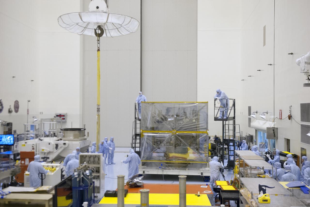 CAPE CANAVERAL, Fla. – Engineers prepare to remove shipping material from around NASA’s Mars Atmosphere and Volatile Evolution MAVEN spacecraft inside the Payload Hazardous Servicing Facility on Aug. 3, 2013, at the agency’s Kennedy Space Center in Florida. MAVEN will be prepared inside the facility for its scheduled November launch to Mars. Positioned in an orbit above the Red Planet, MAVEN will study the upper atmosphere of Mars in unprecedented detail. Photo credit: NASA/Tim Jacobs