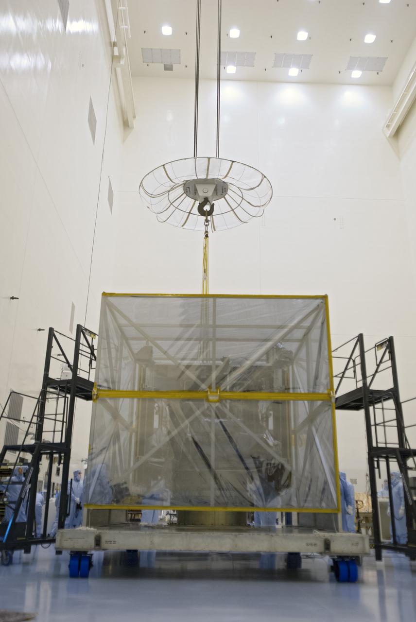 CAPE CANAVERAL, Fla. – A crane begins to lift shipping material from around NASA’s Mars Atmosphere and Volatile Evolution MAVEN spacecraft inside the Payload Hazardous Servicing Facility on Aug. 3, 2013, at the agency’s Kennedy Space Center in Florida. MAVEN will be prepared inside the facility for its scheduled November launch to Mars. Positioned in an orbit above the Red Planet, MAVEN will study the upper atmosphere of Mars in unprecedented detail. Photo credit: NASA/Tim Jacobs